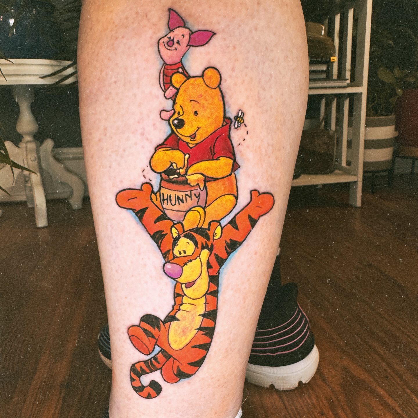 Winnie the Pooh and friends illustrative tattoo on the leg by Eric Burns - NoVA Tattoo Artist