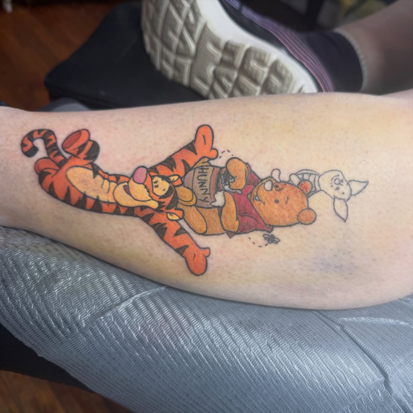 Winnie the Pooh and friends illustrative tattoo on the forearm by Eric Burns - NoVA Tattoo Artist