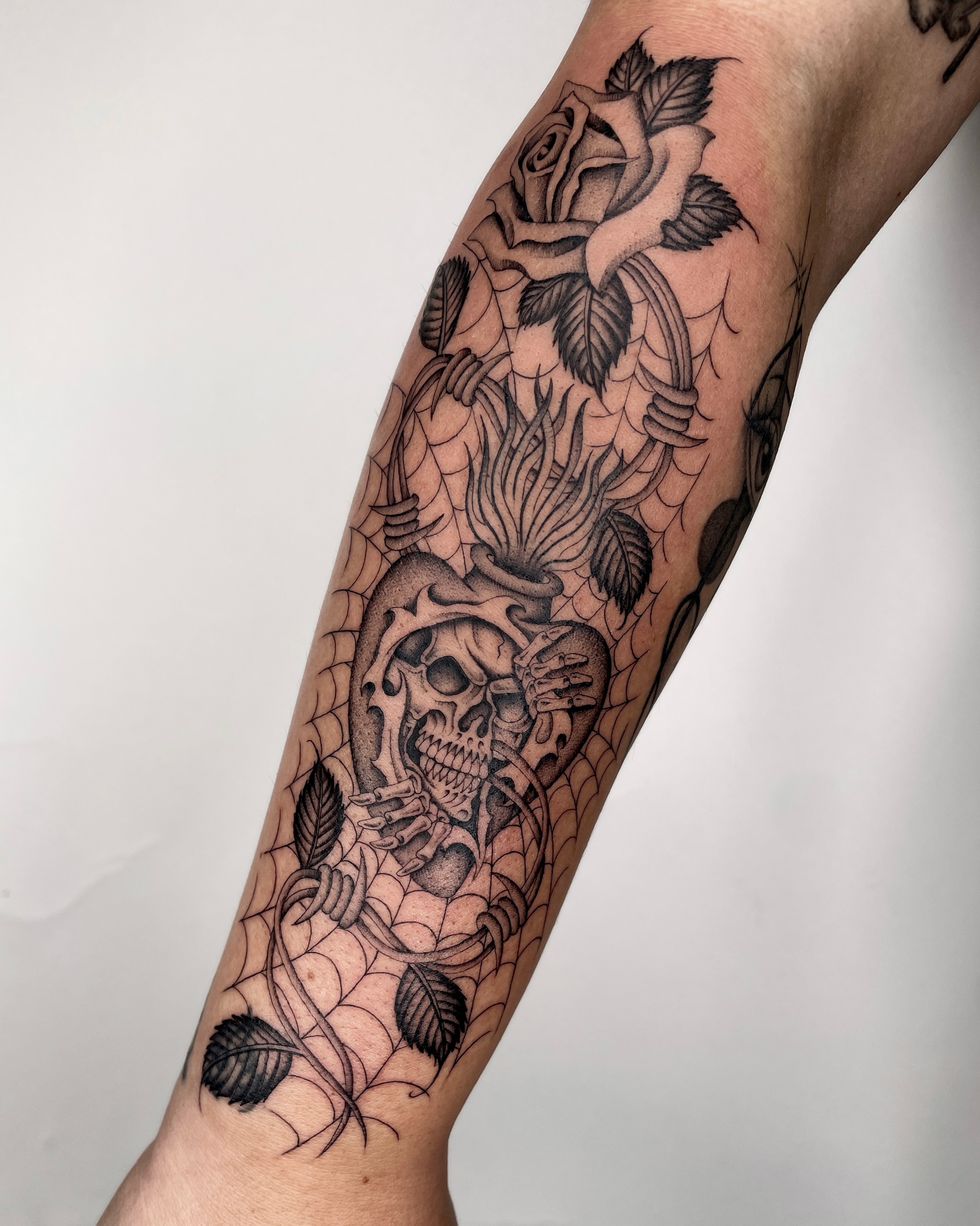 Skull and rose realism tattoo on the forearm by IVY