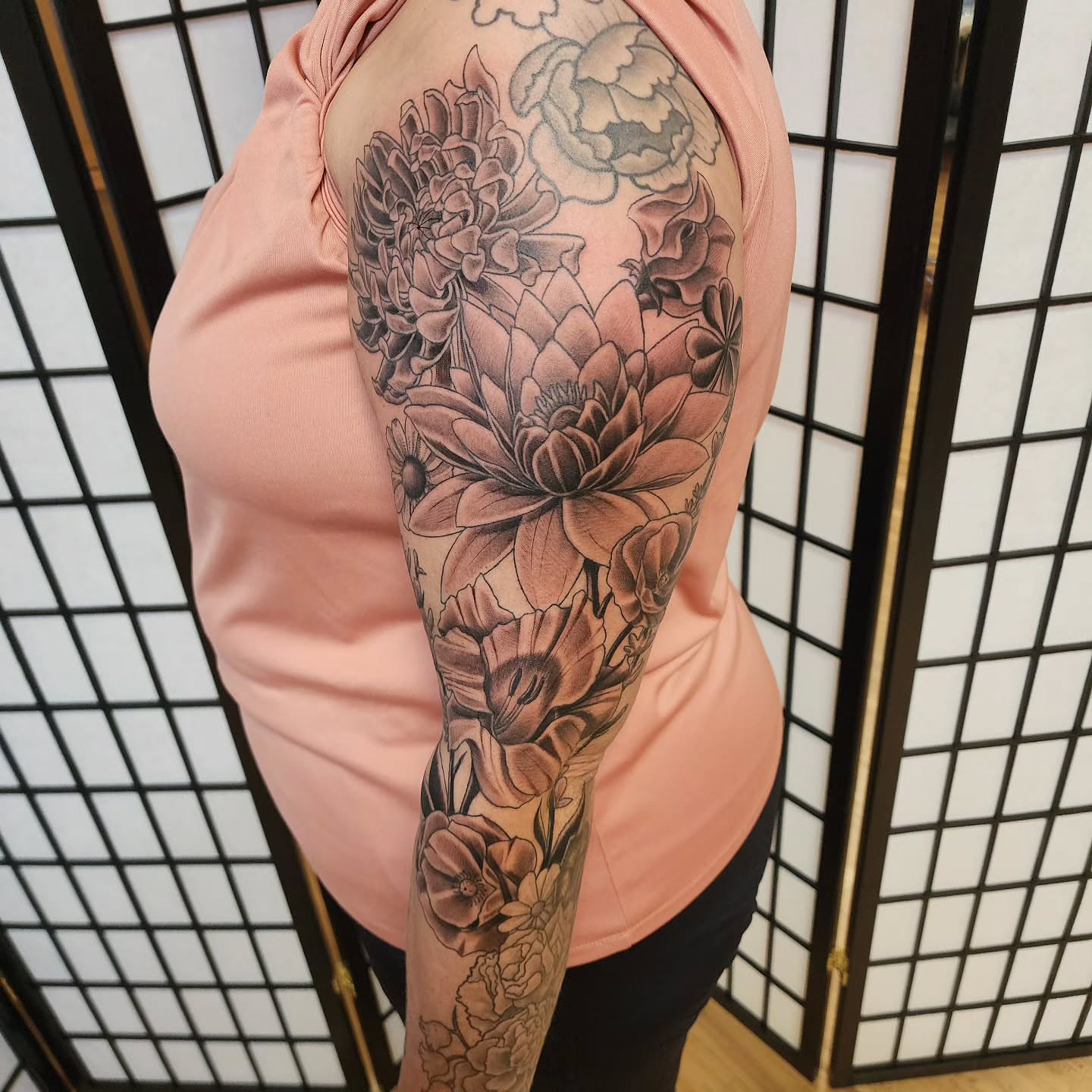 Floral bouquet black and grey tattoo on the upper arm by Anthony Moncada