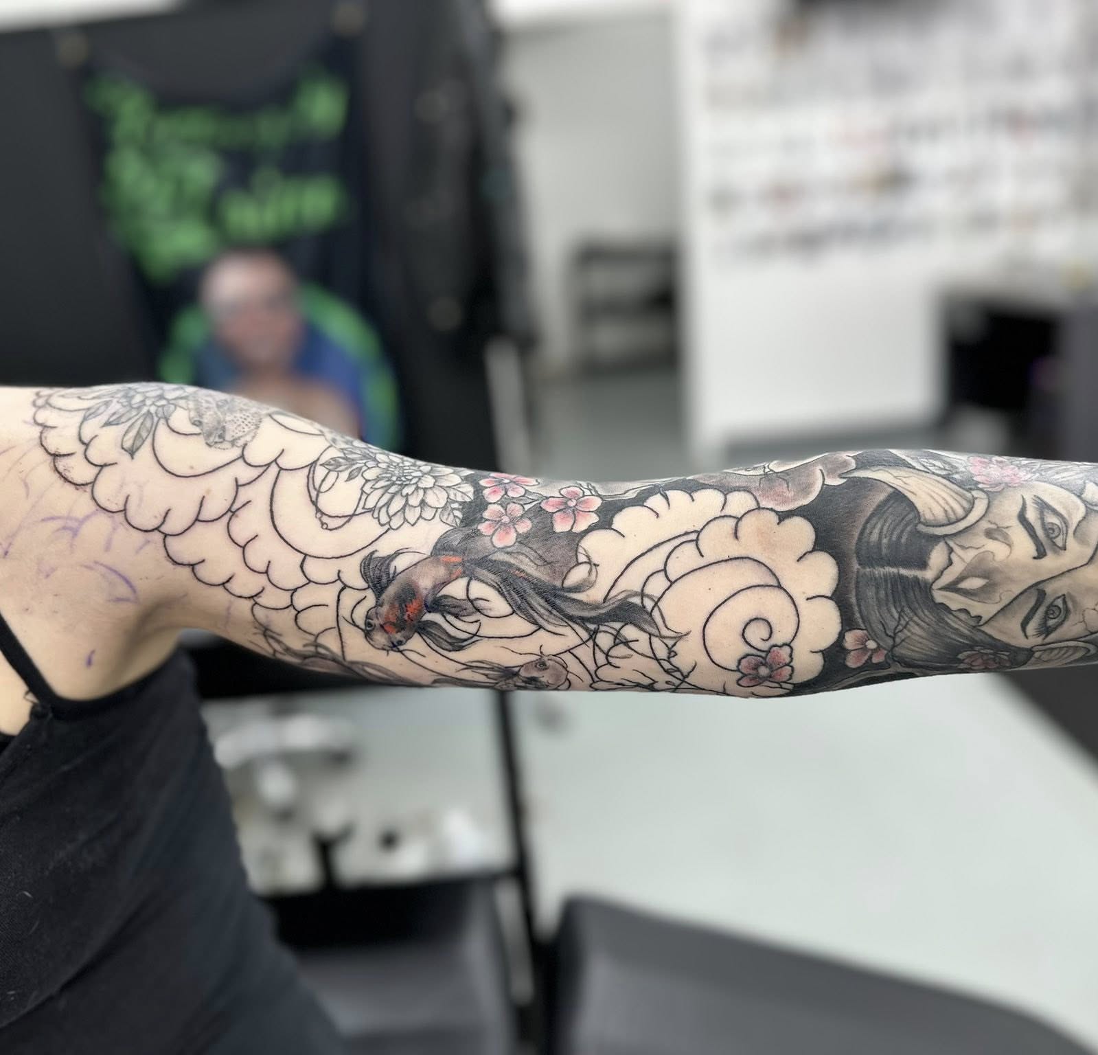 Woman with fish japanese irezumi tattoo on the forearm by Brian Lambert
