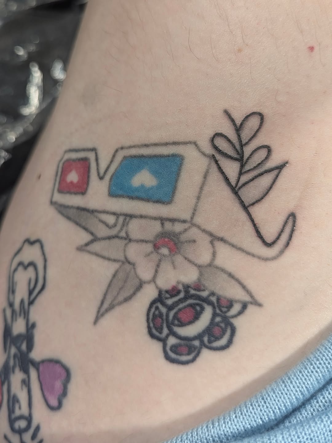 3D glasses and flowers tattoo on the forearm by licensed charlotte tattoo artist