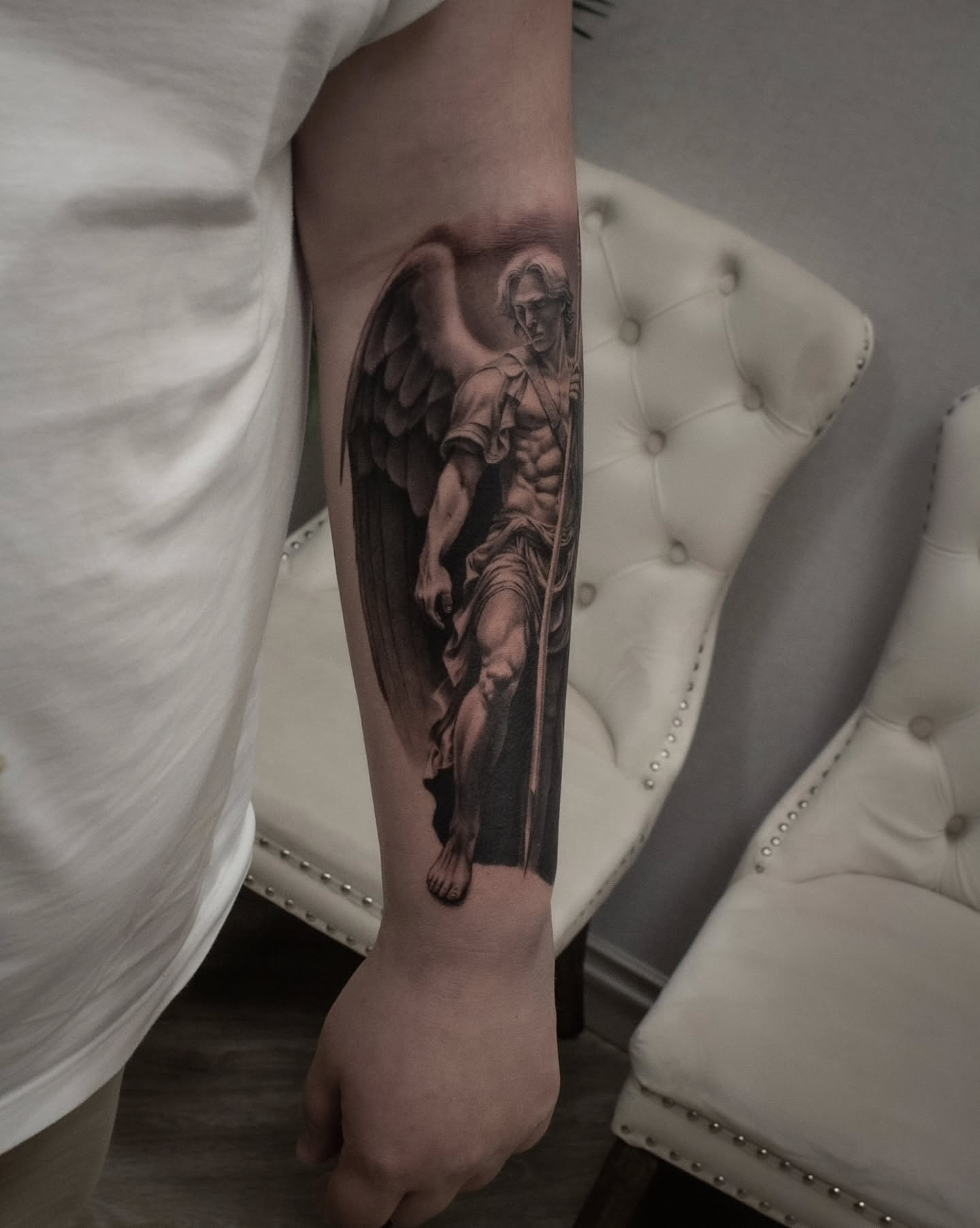 Angel statue realism tattoo on the forearm by Erik Bonilla