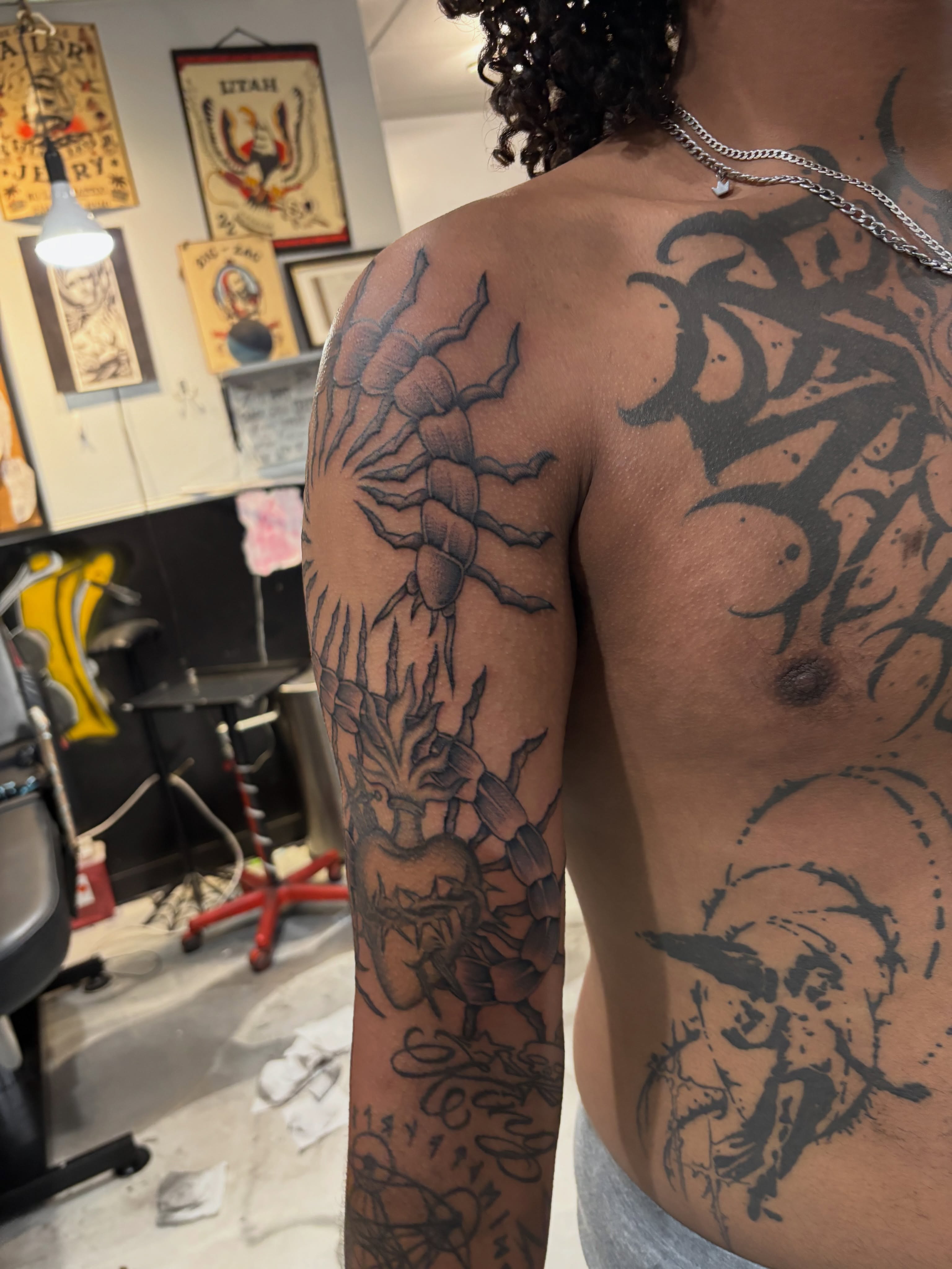 Scorpion and heart black and grey tattoo on the upper arm by Miklo Montoya
