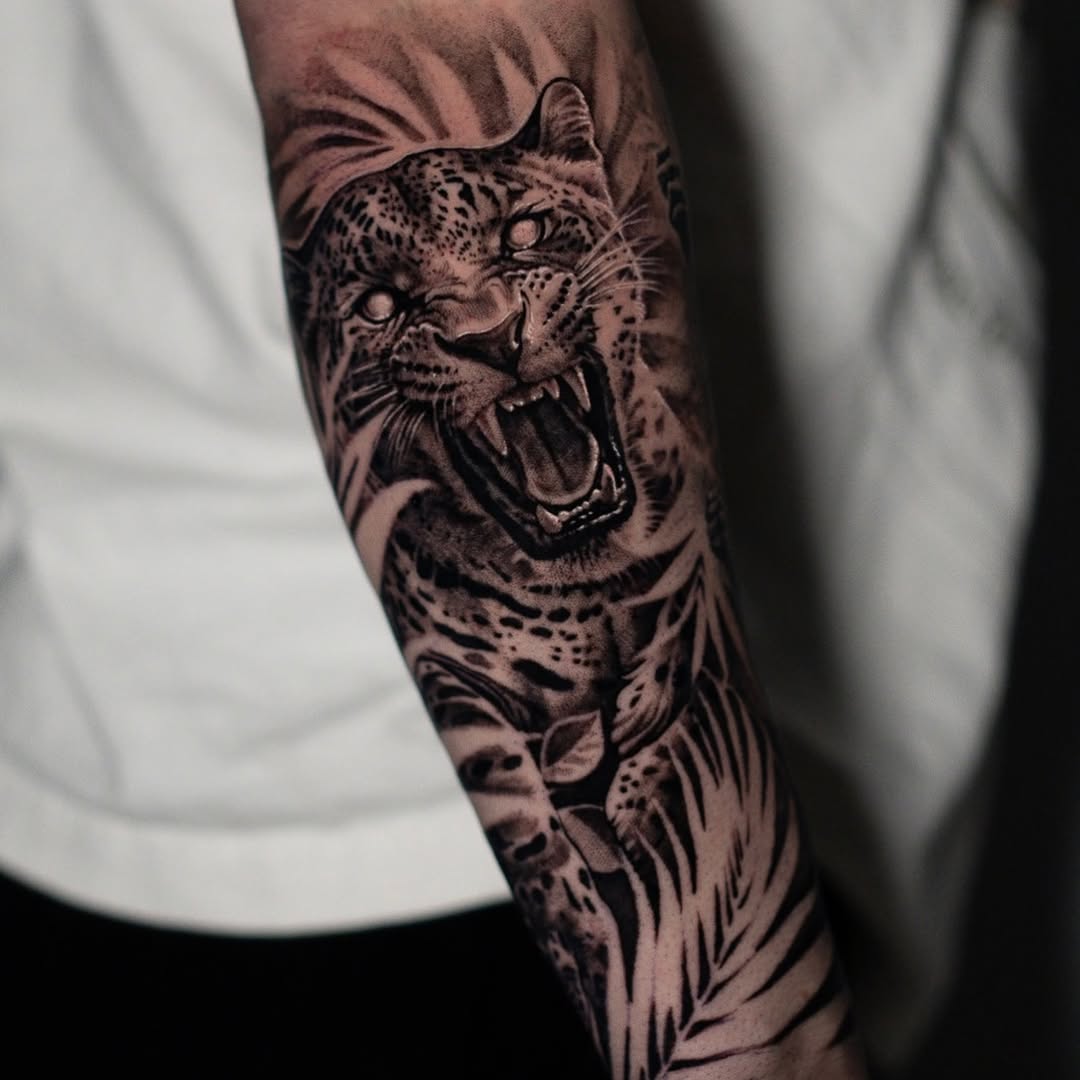 Roaring leopard realism tattoo on the forearm by Mark Vata