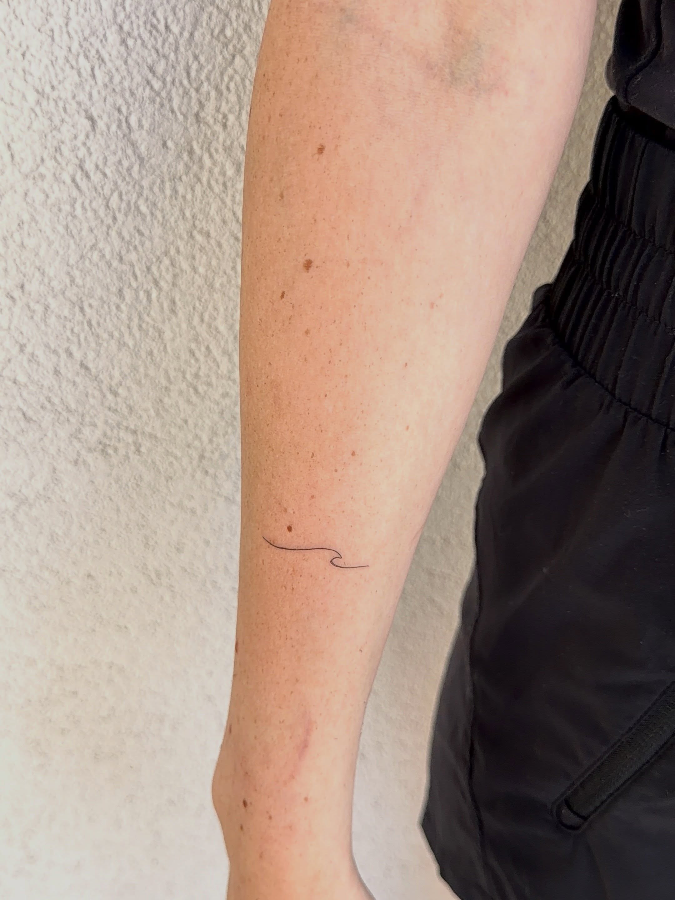 Wave fine line tattoo on the forearm by Jacksyn, Plano, Texas