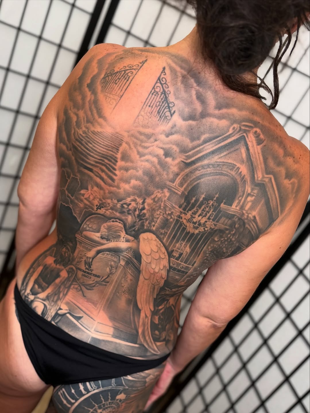 Heavenly gates and angel realism tattoo on the back by Anthony Ramirez