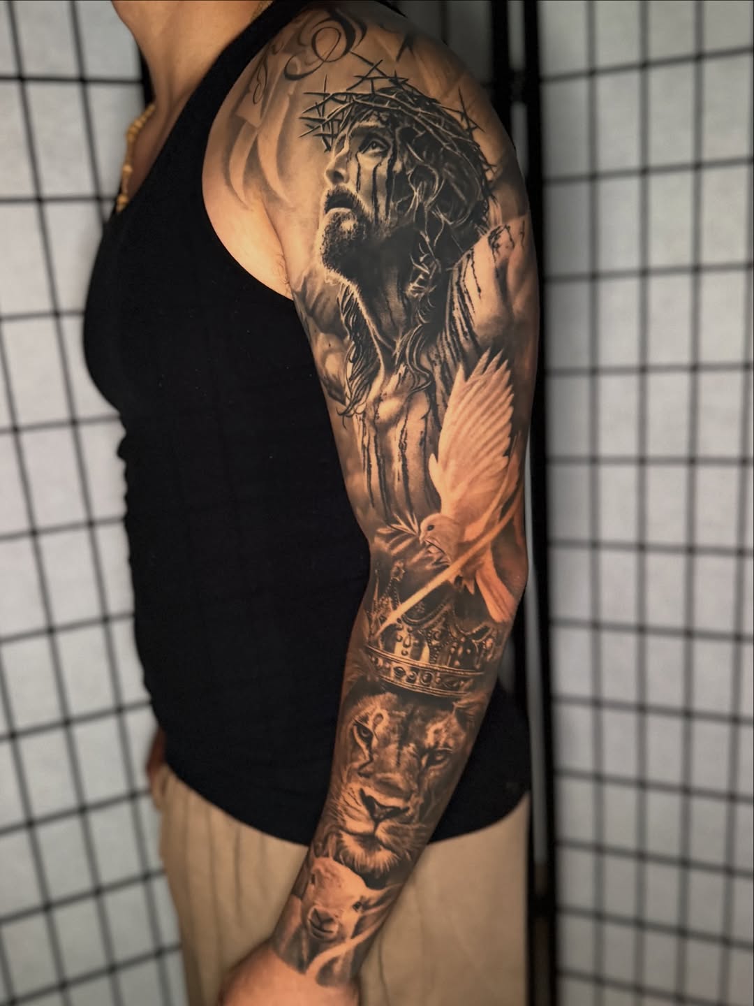 Jesus, lion, lamb, and dove realism tattoo on the forearm by Anthony Ramirez