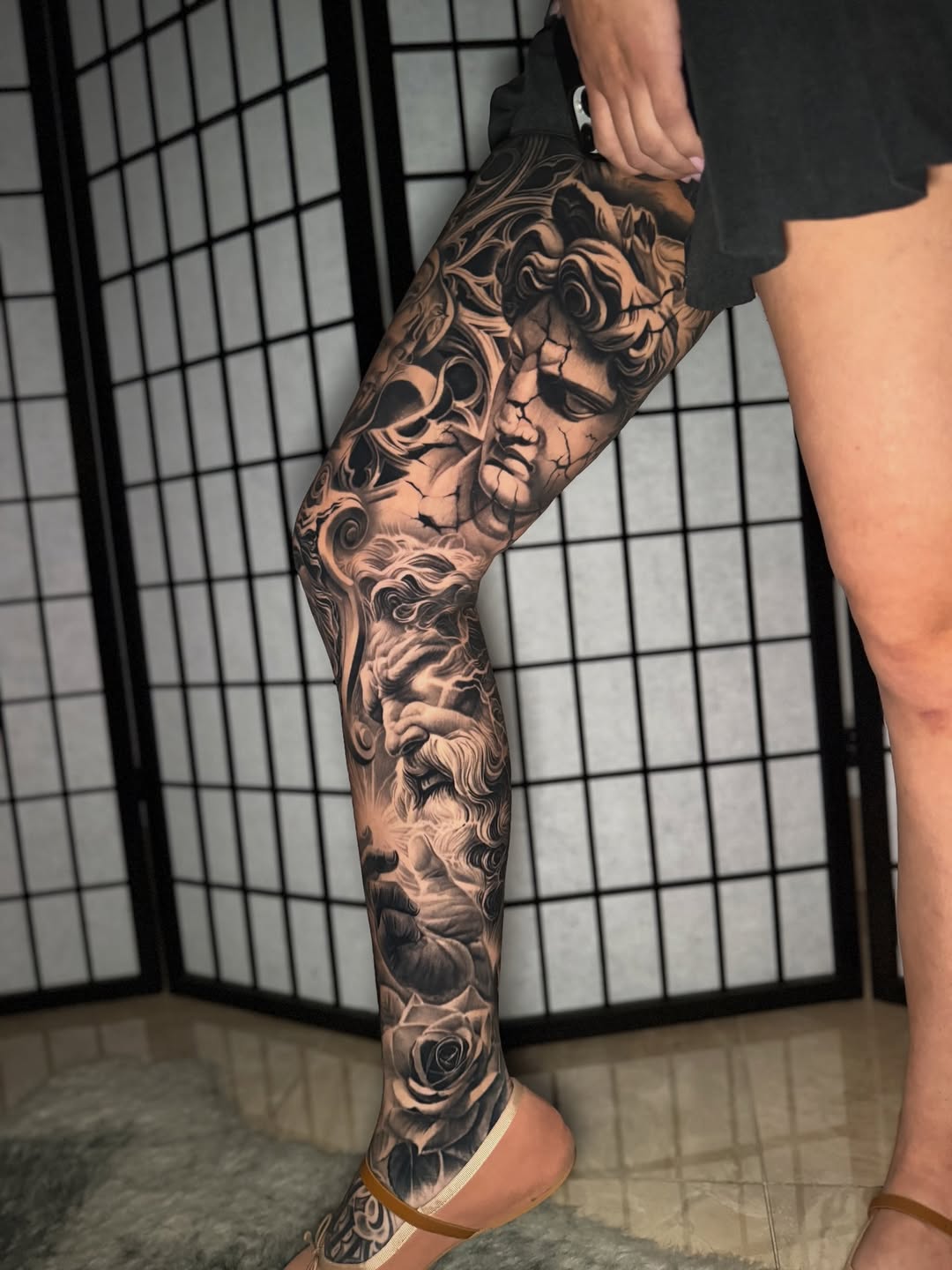 Classical sculpture and rose Japanese tattoo on the calf by Anthony Ramirez