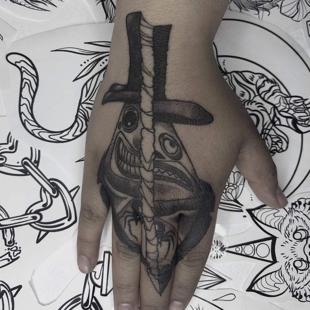 Creepy face with hat realism tattoo on the hand by Weho Tattoo Artist Lupe