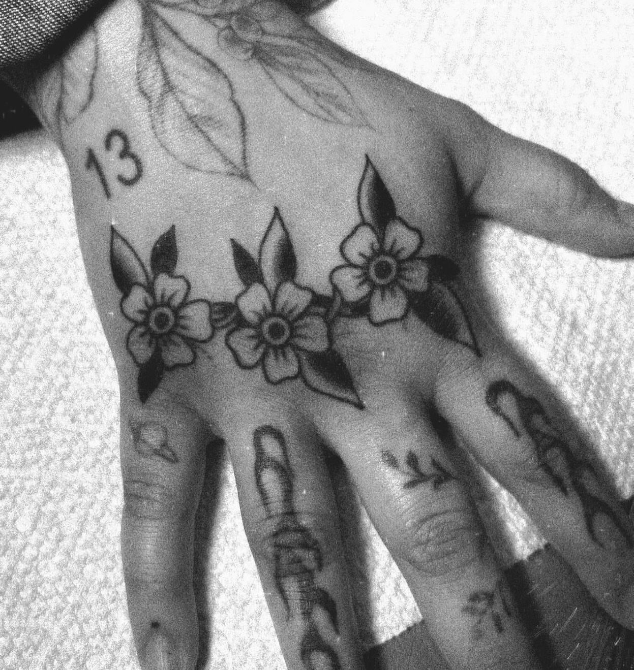 Flowers American traditional tattoo on the hand by Caeli Martin