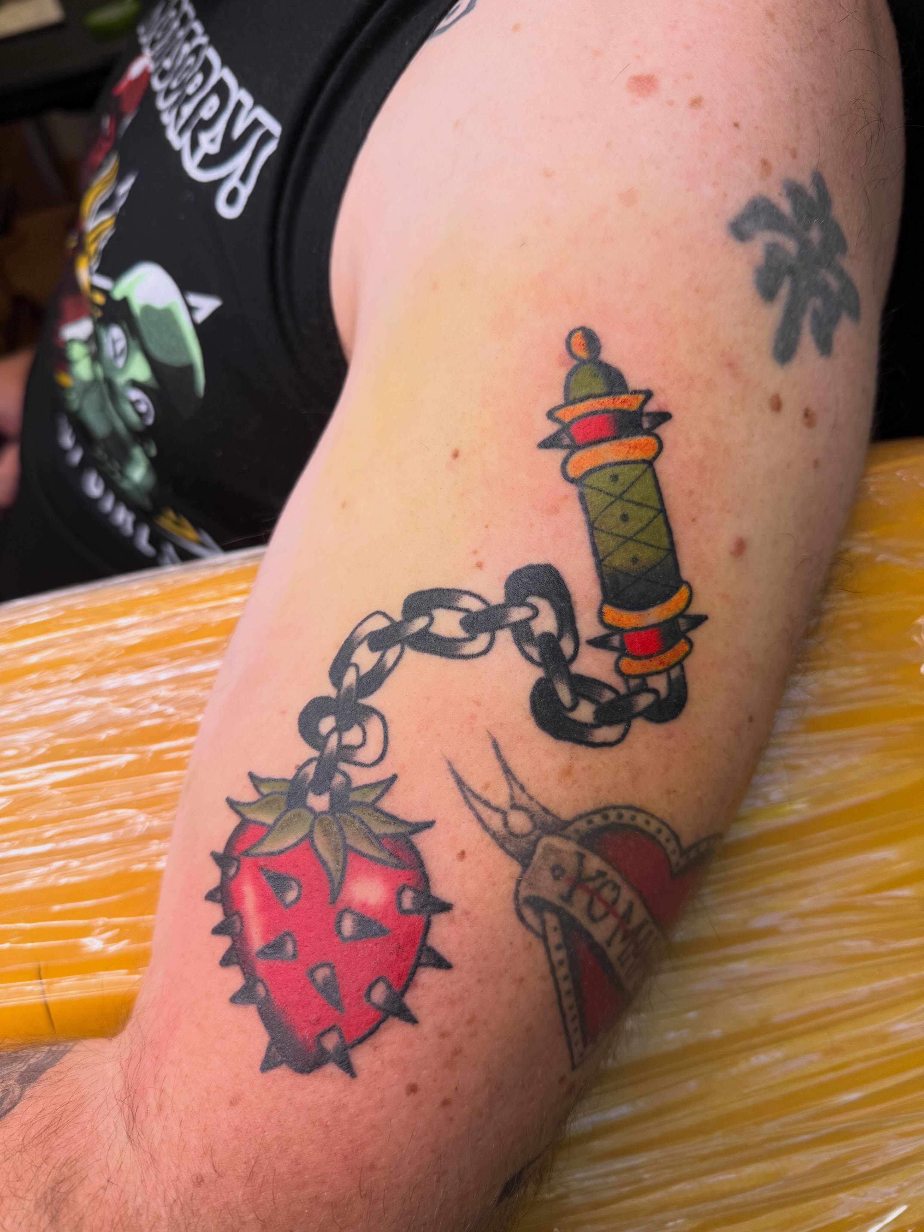 Chain, dagger, strawberry American traditional tattoo on the forearm by Liz🗡️Fort Collins🗡️Tattoo Apprentice
