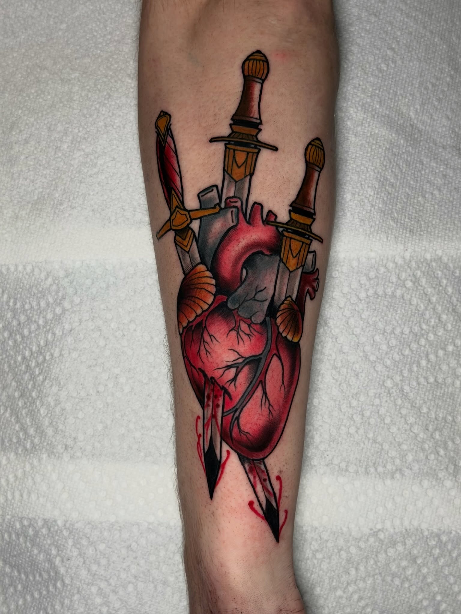 Heart with knives American traditional tattoo on the forearm by 𝐀𝐧𝐝𝐲 𝐁𝐚𝐠𝐥𝐞𝐲