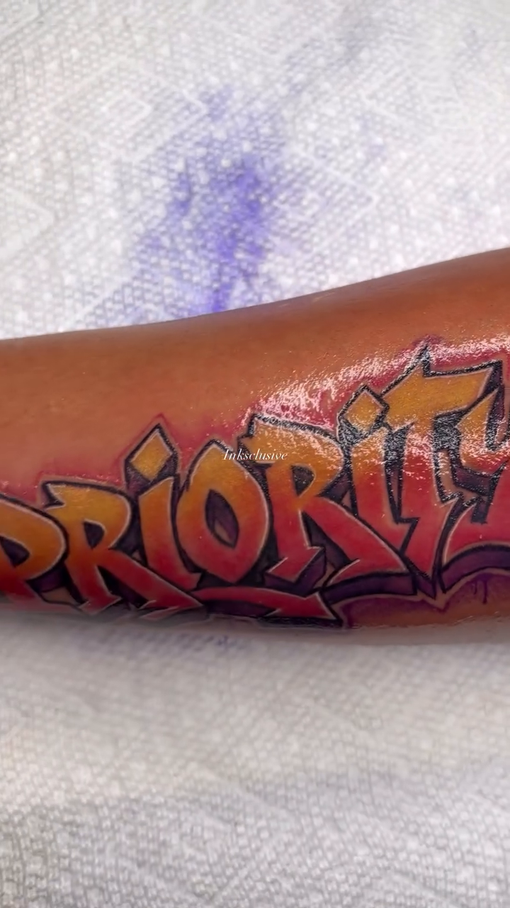 Graffiti style lettering lettering tattoo on the forearm by Ed Forrest