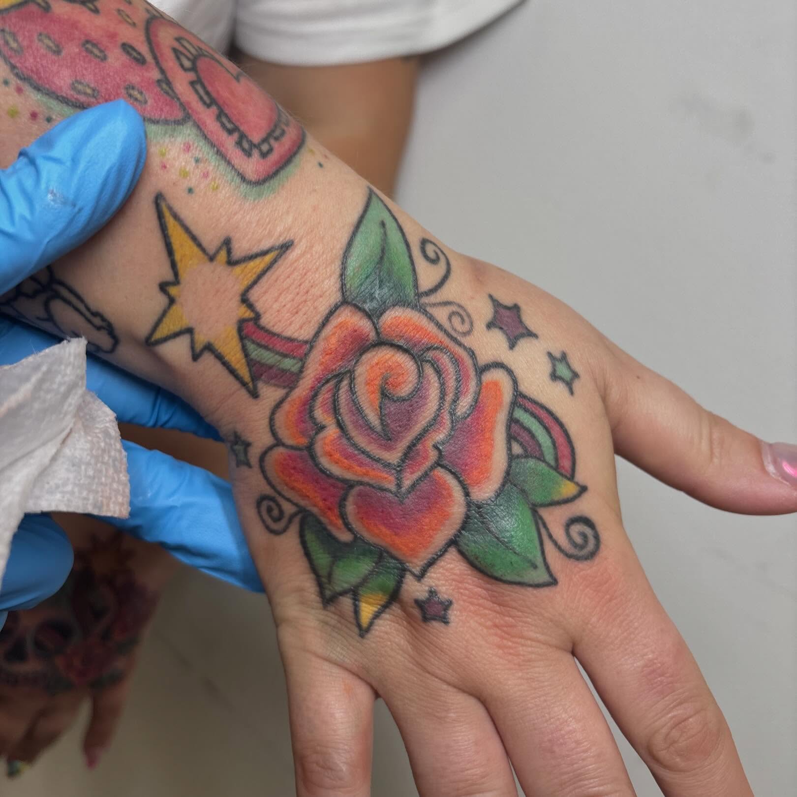 Rose and heart American traditional tattoo on the hand by Taylor  Thompson