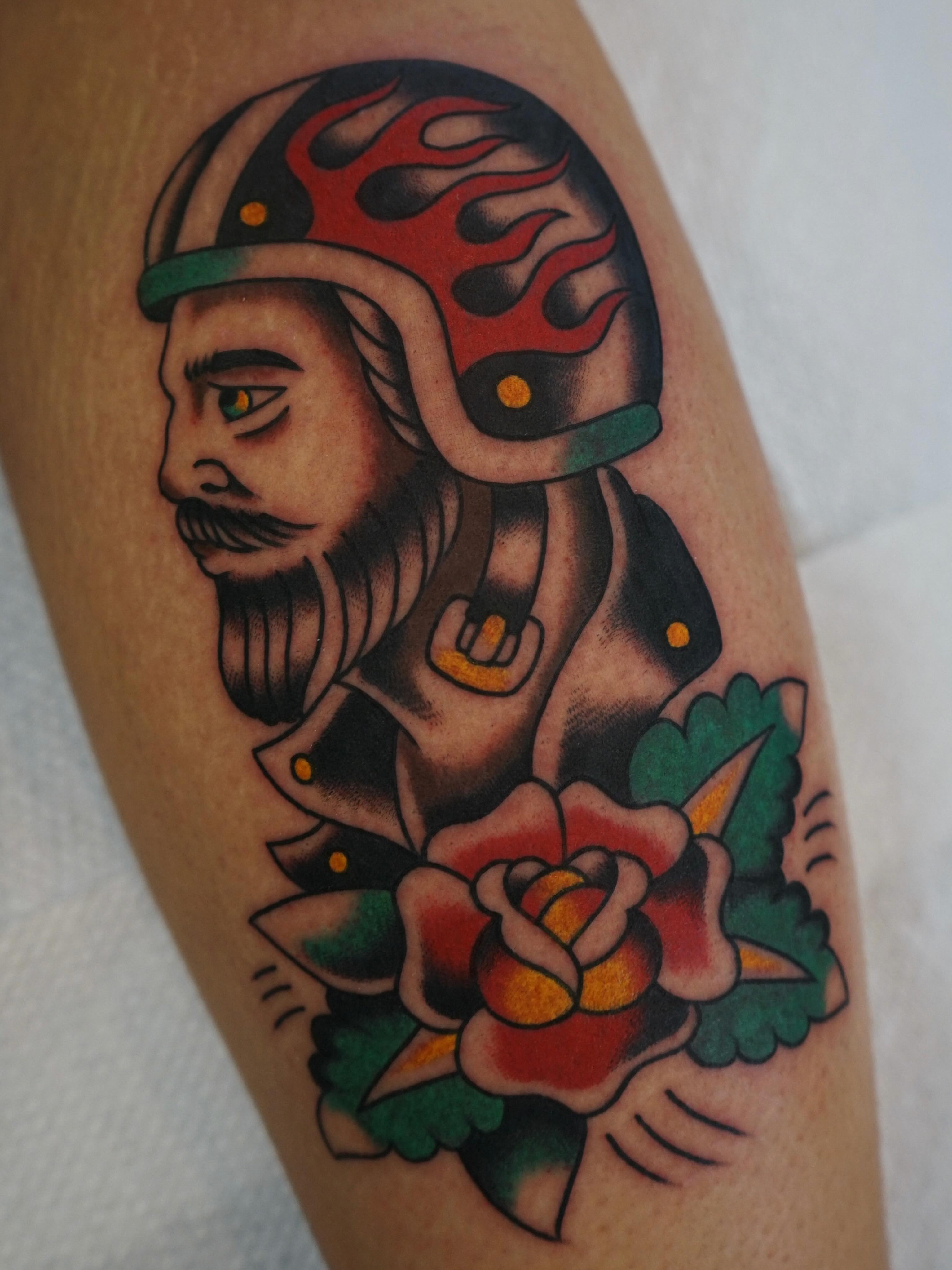 Motorcycle rider with helmet American traditional tattoo on the forearm by Emily Devenz