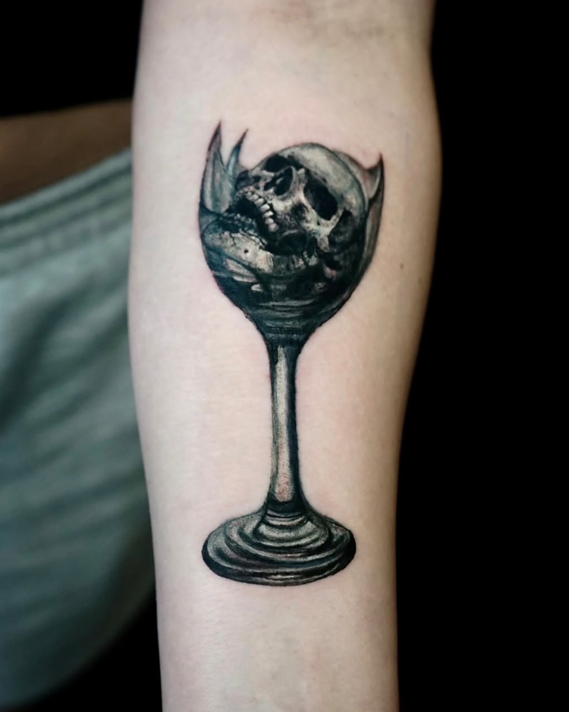 Wine glass with skull realism tattoo on the forearm by Nyahzul - Glitch Tattoo Artist NYC