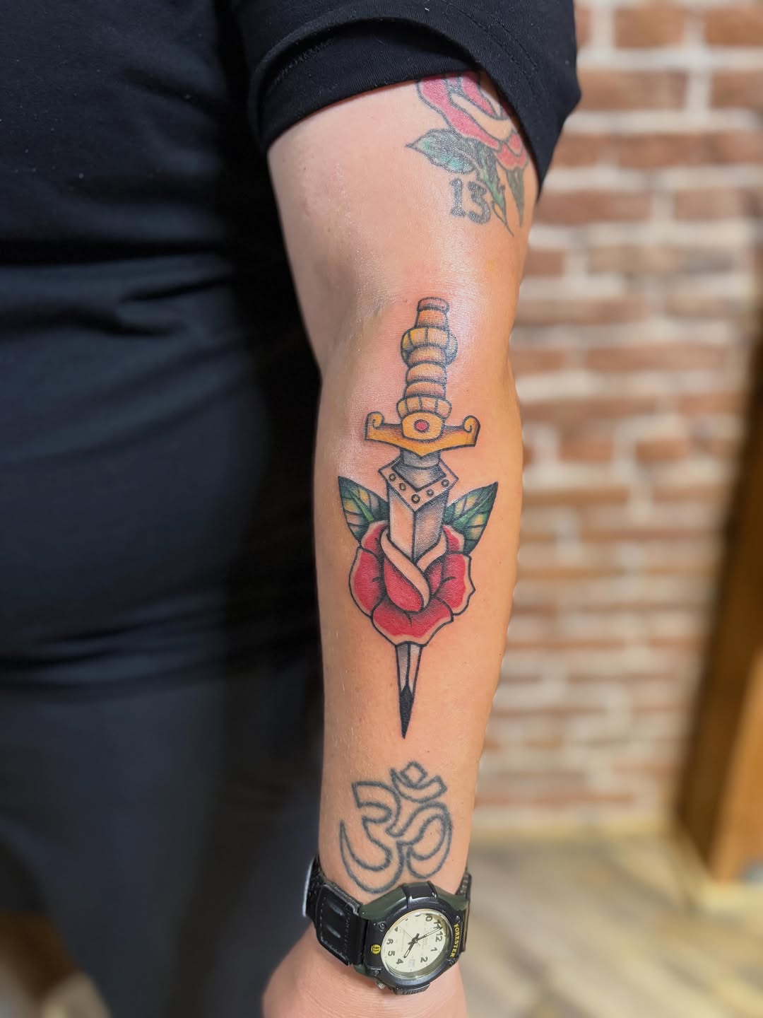 Dagger and rose American traditional tattoo on the forearm by Tattoo Artist, Kansas City, Missouri