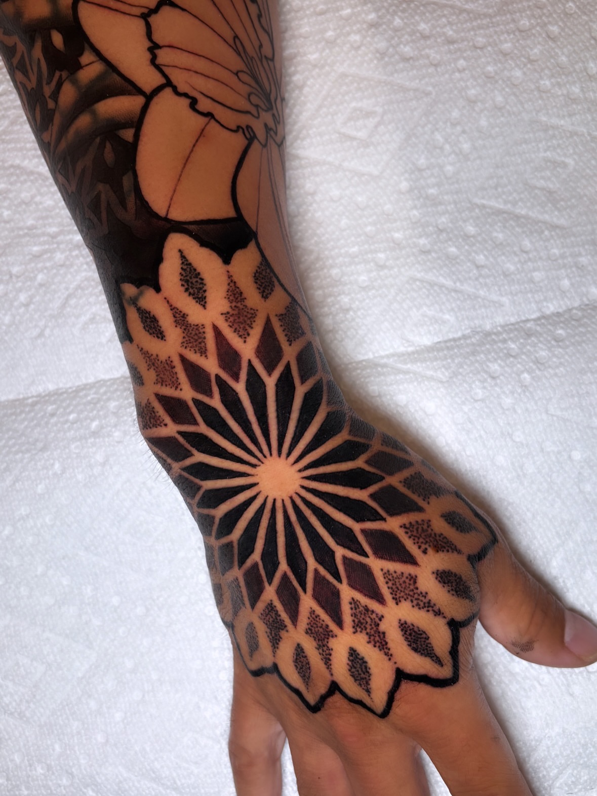 Geometric mandala dotwork tattoo on the forearm by Tony Lucero, Wheat Ridge, Colorado