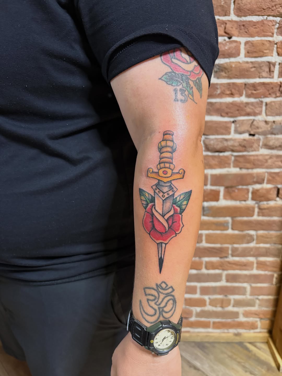 Dagger through rose American traditional tattoo on the forearm by Tattoo Artist, Kansas City, Missouri