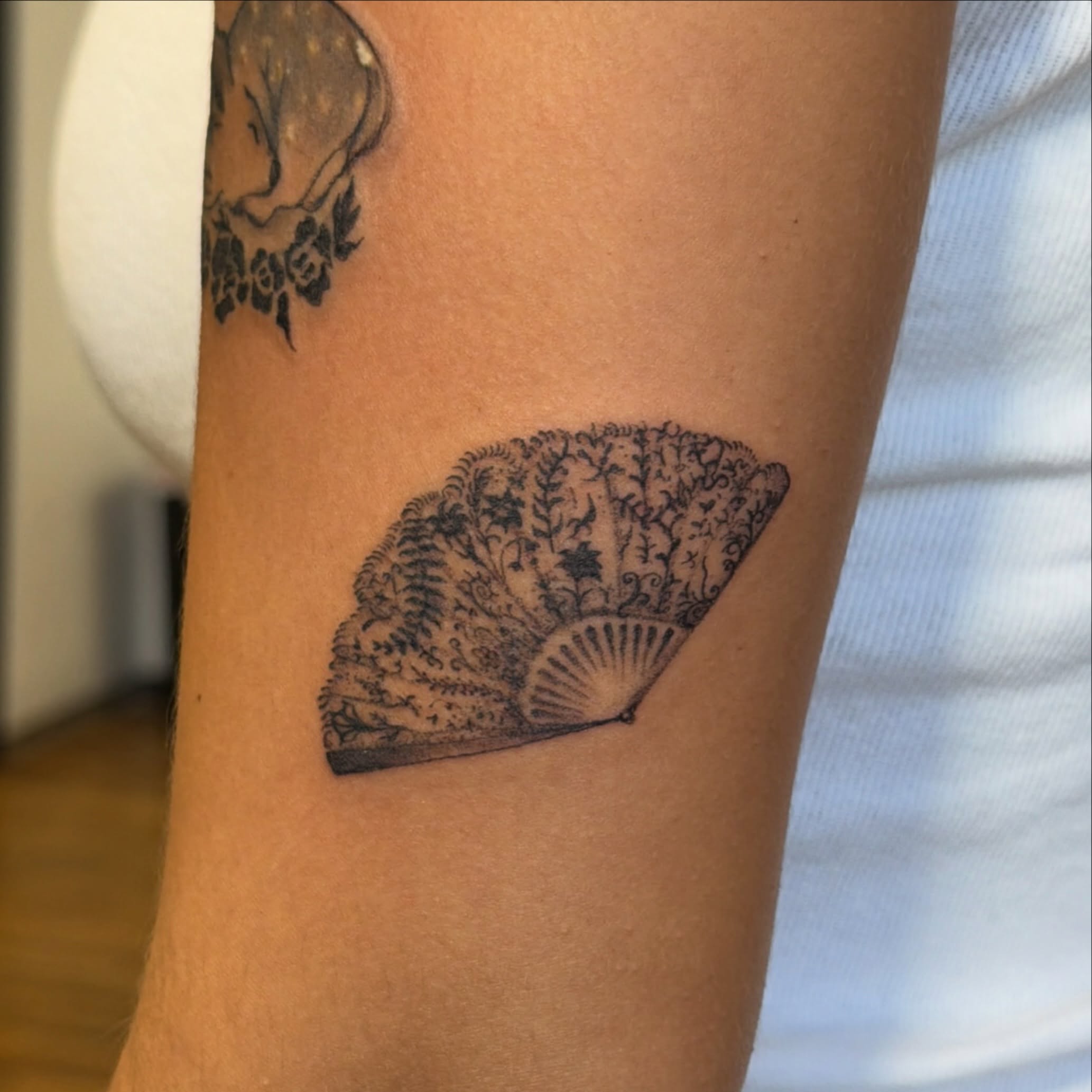 Fan black and grey tattoo on the forearm by Sienna (jj) Hicks