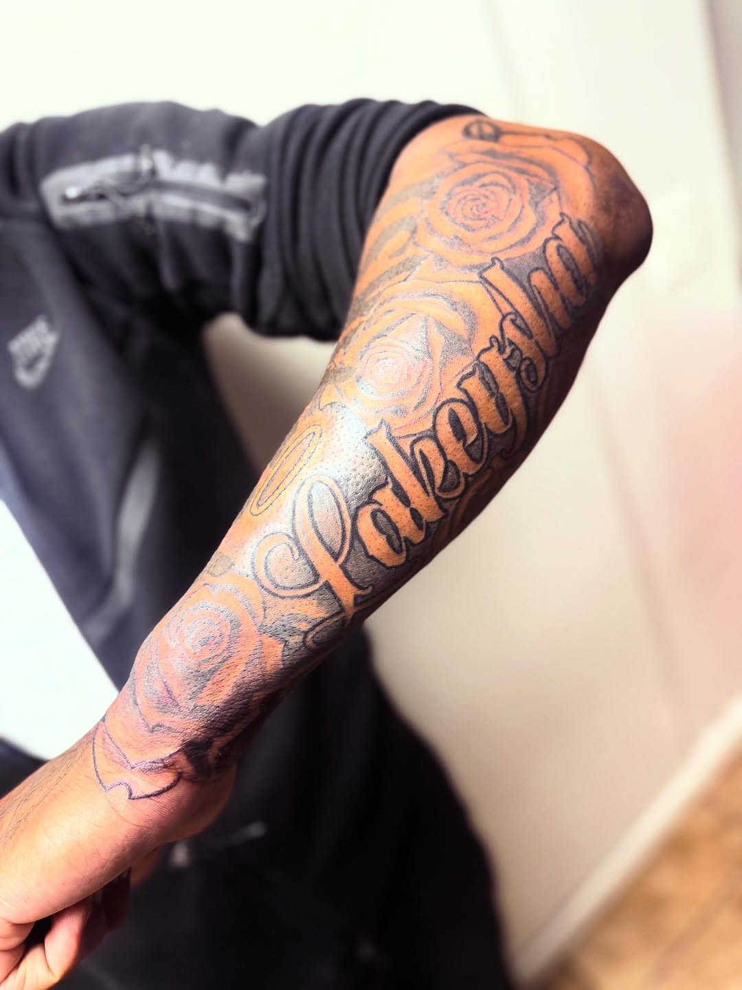 Roses and script lettering lettering tattoo on the forearm by Uncle Fade Tattoo Artist ✍🏾