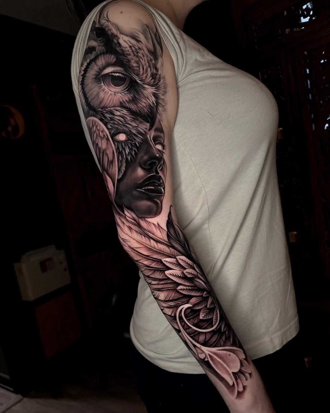 Owl and woman with wings realism tattoo on the upper arm by Sean Flood