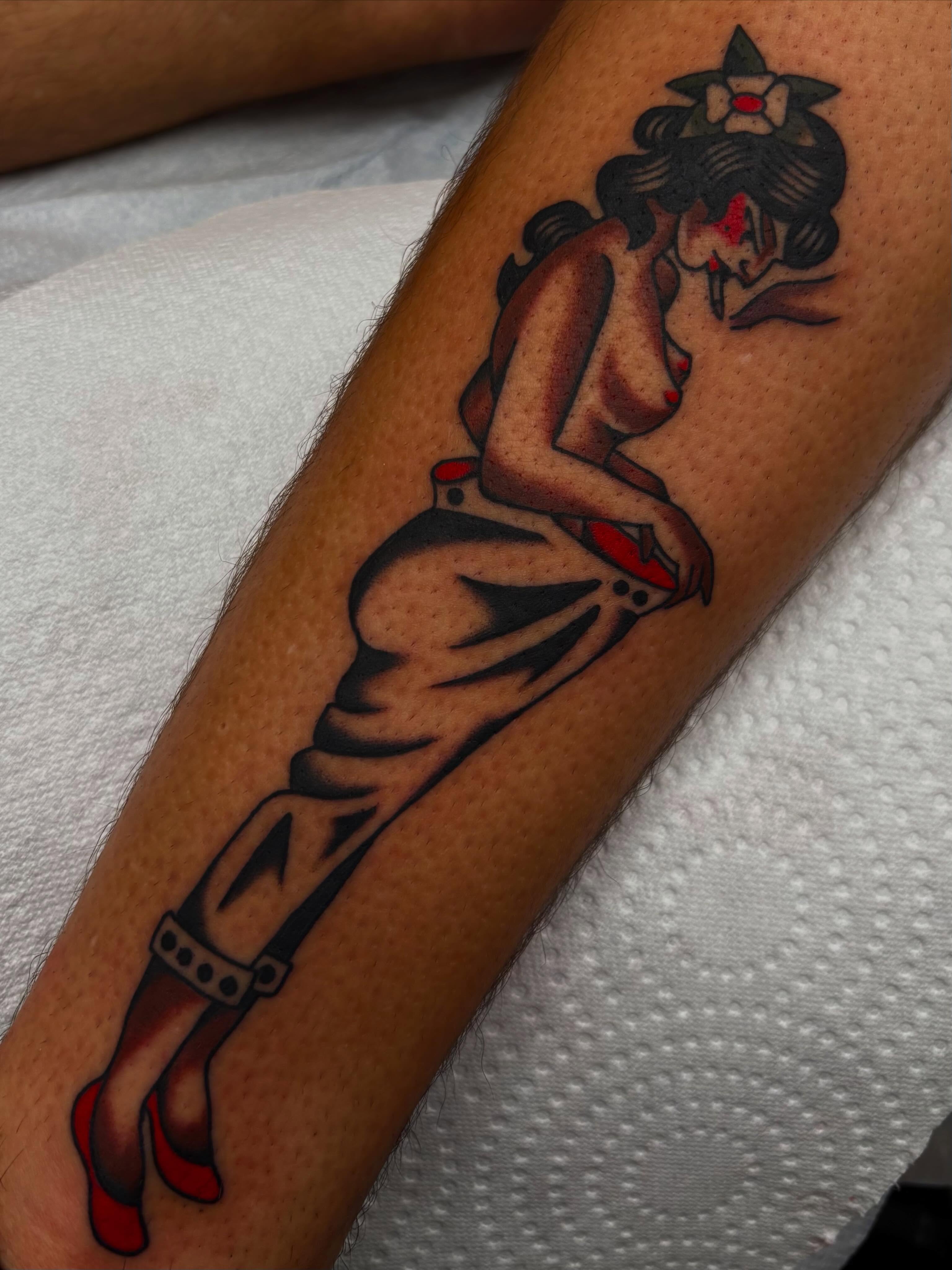 Pin-up girl American traditional tattoo on the forearm by Claire Anderson