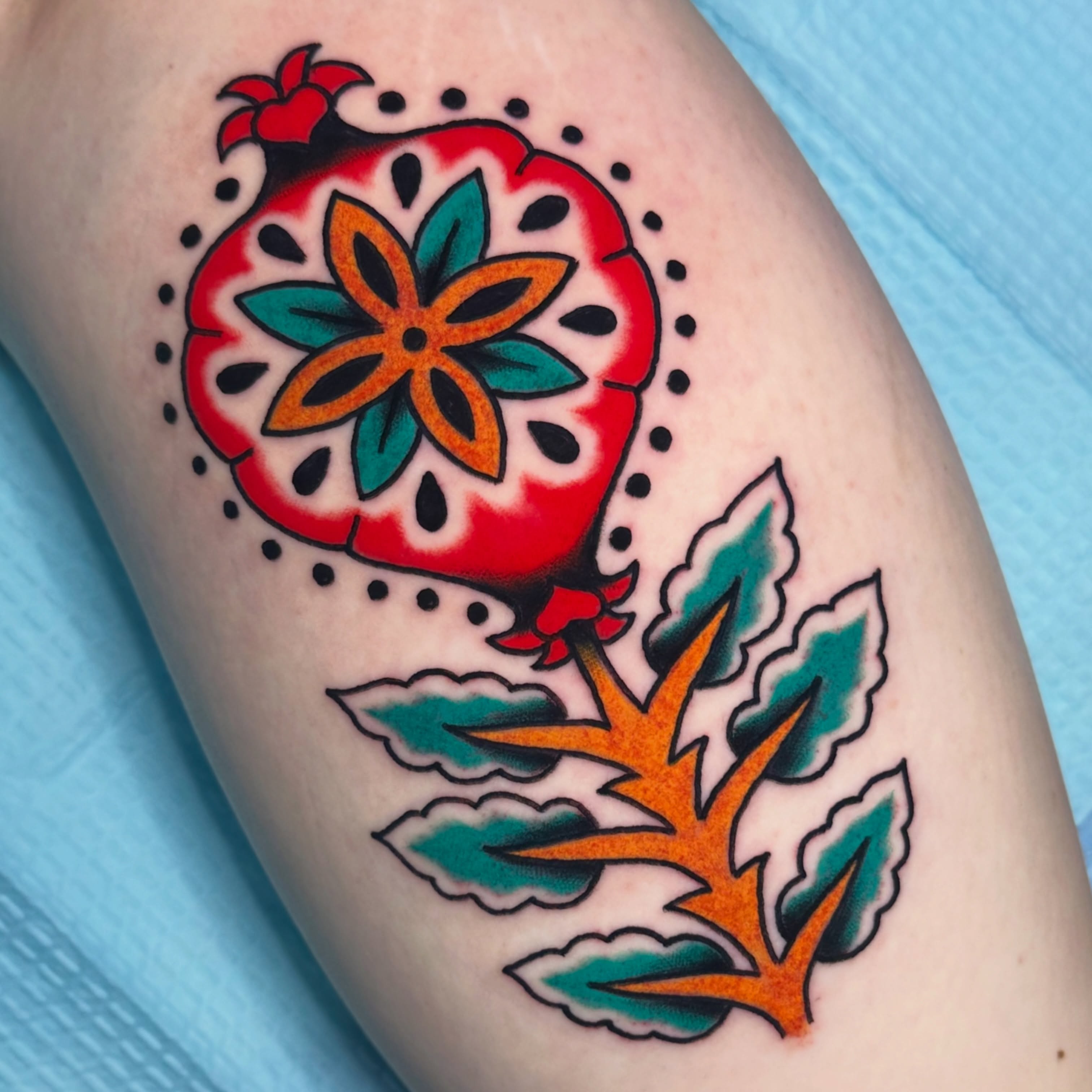 Pomegranate American traditional tattoo on the thigh by Kiki Painmaker Trad Tattooer 🧨