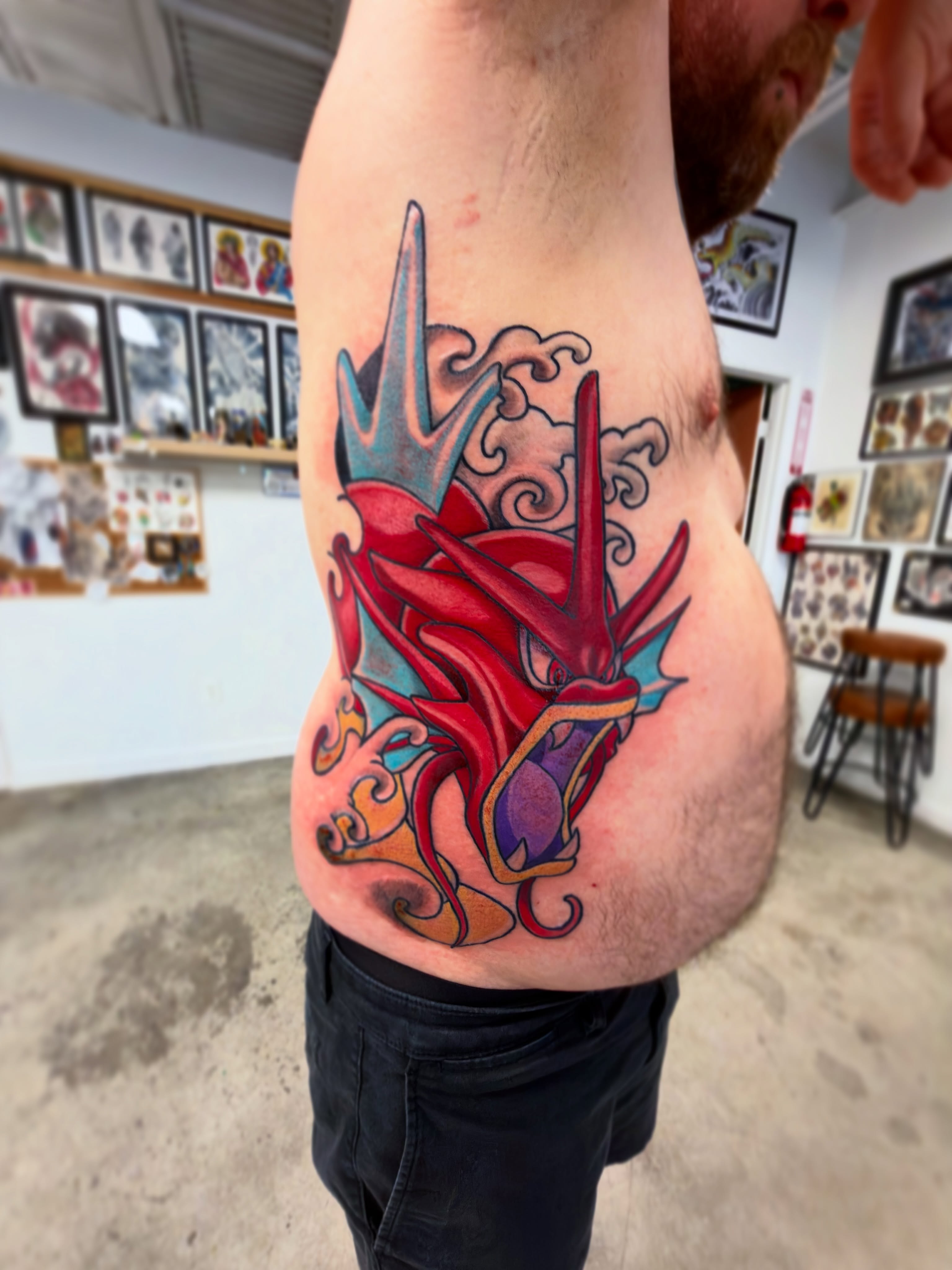 Dragon new school tattoo on the ribs by Christopher Layman
