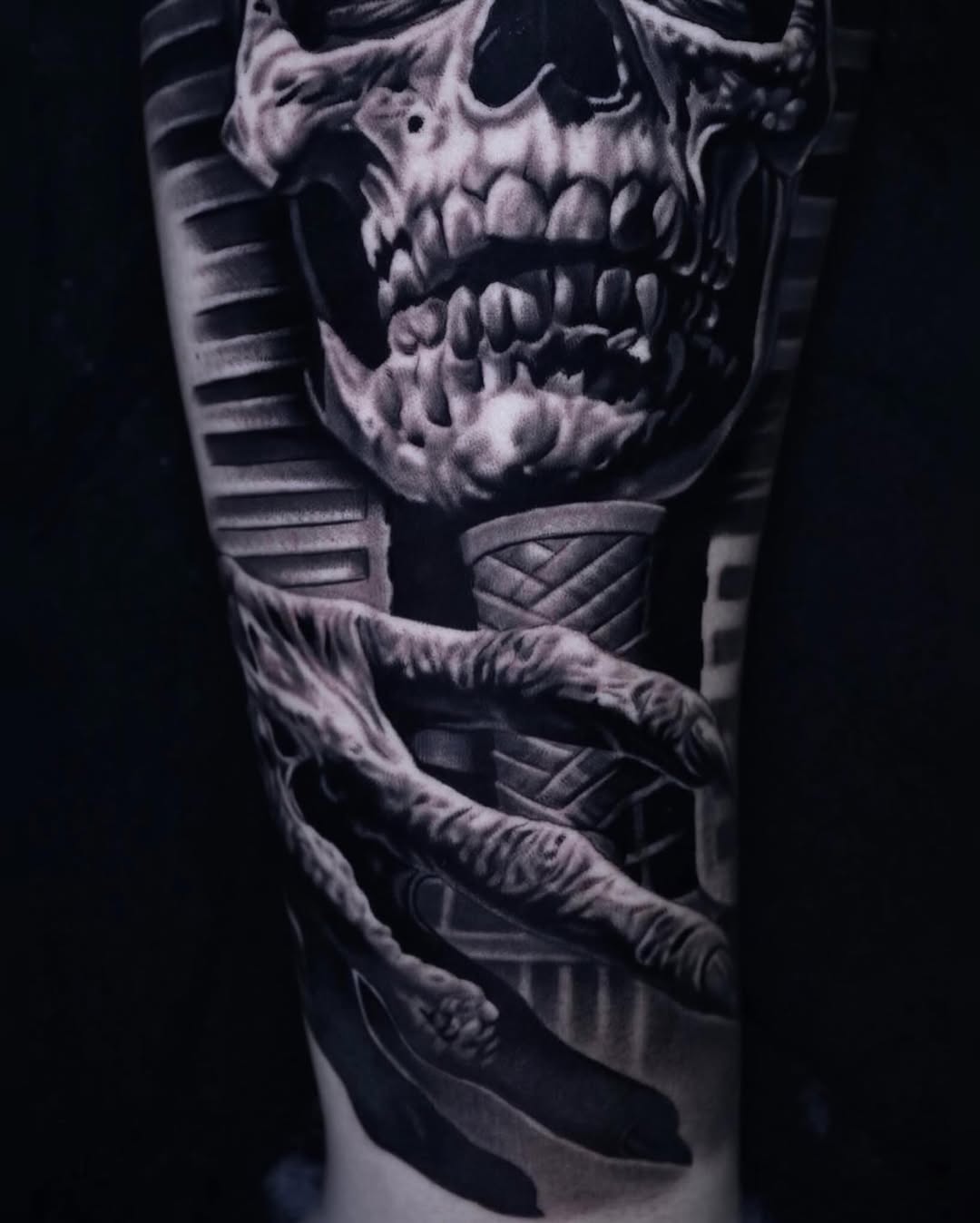 Skull and mummy hand dark art tattoo on the forearm by Sadier Alfonso