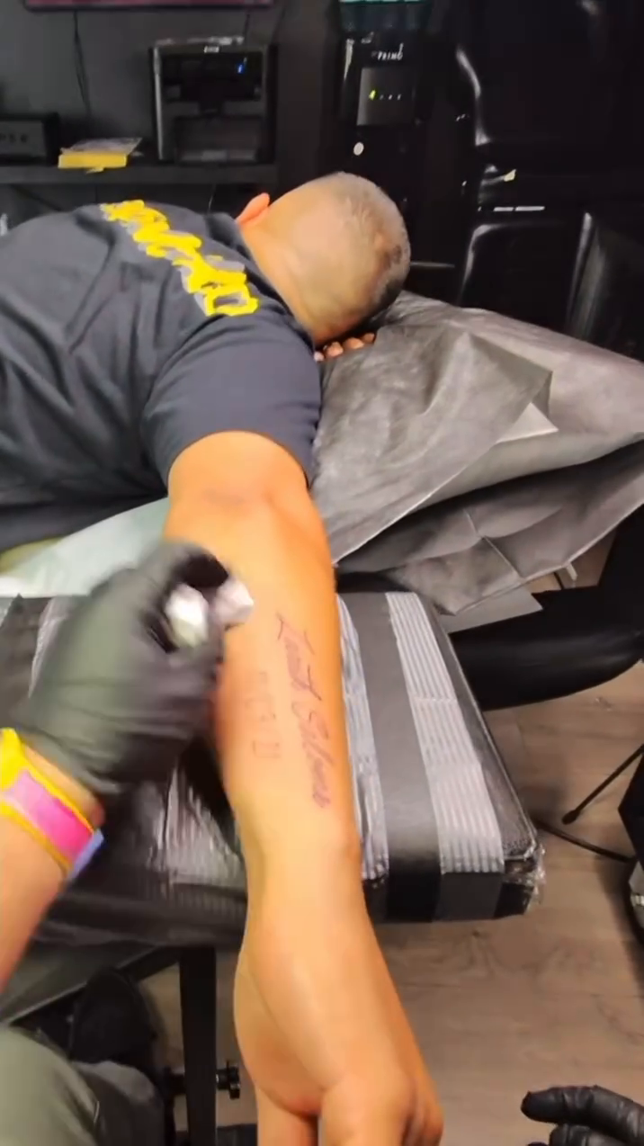 Script tattoo on arm lettering tattoo on the upper arm by Greg Romero (el chamo), Millcreek, Utah