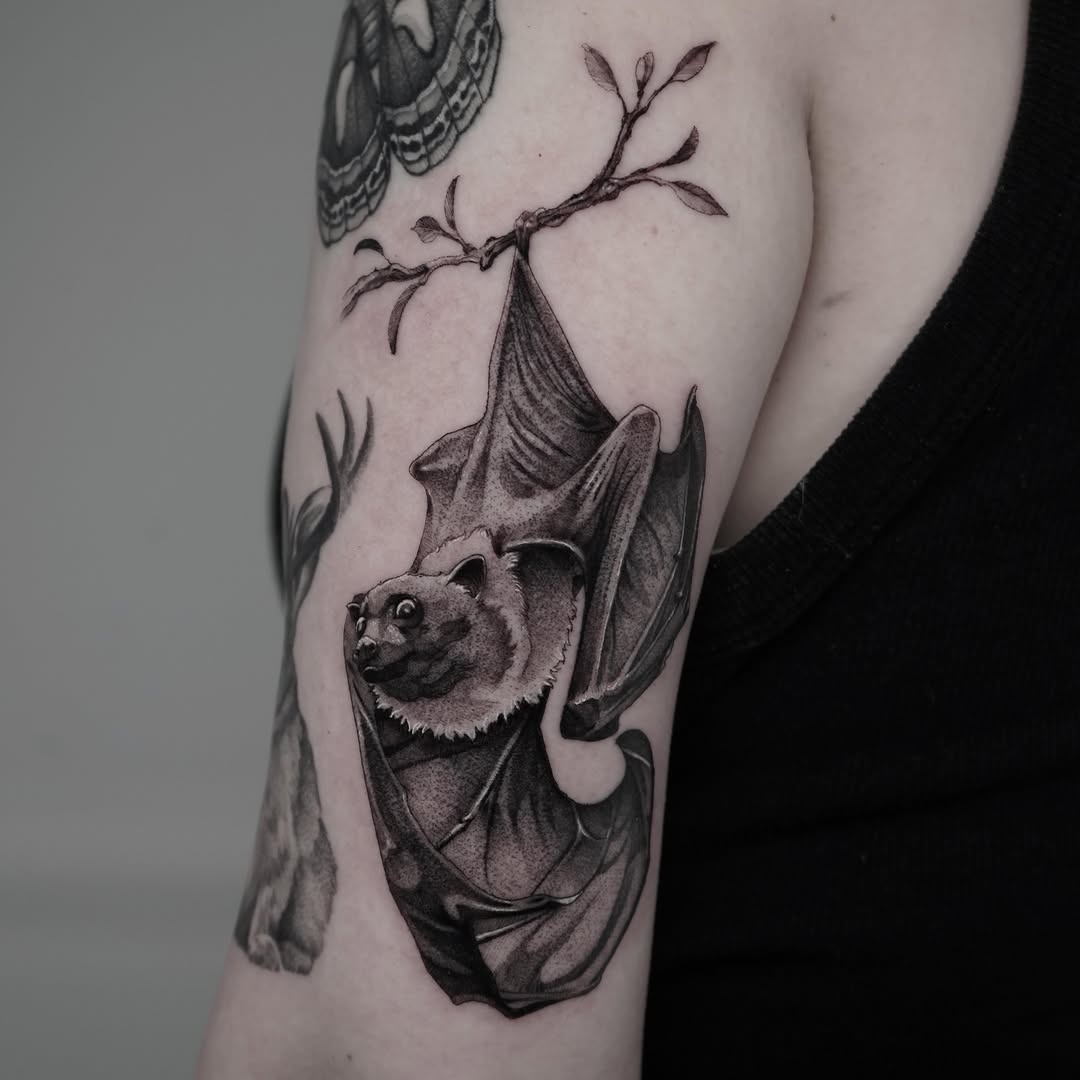 Bat hanging from a branch dotwork tattoo on the forearm by Drew Nelson