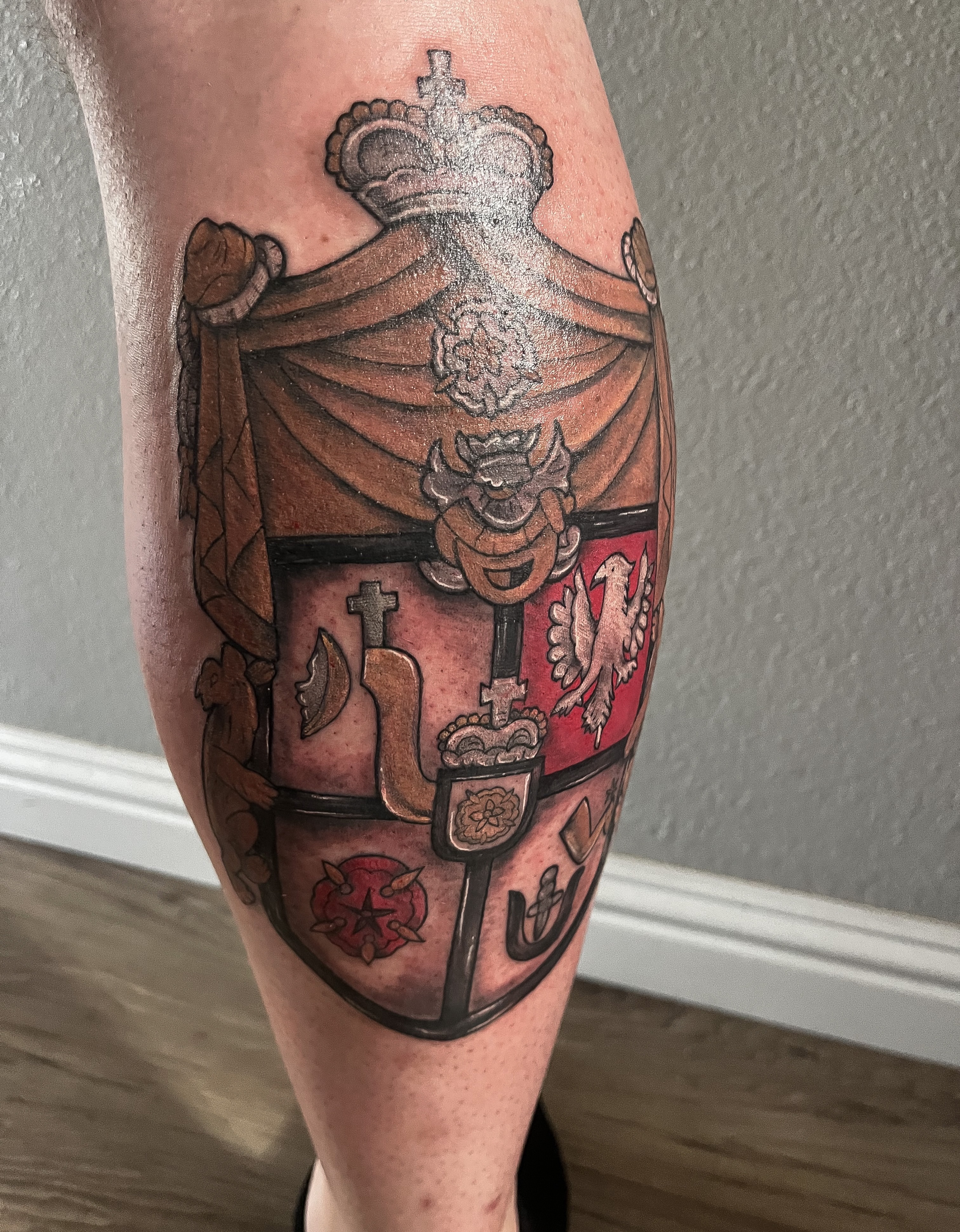 Coat of arms American traditional tattoo on the calf by Janelle Cuba