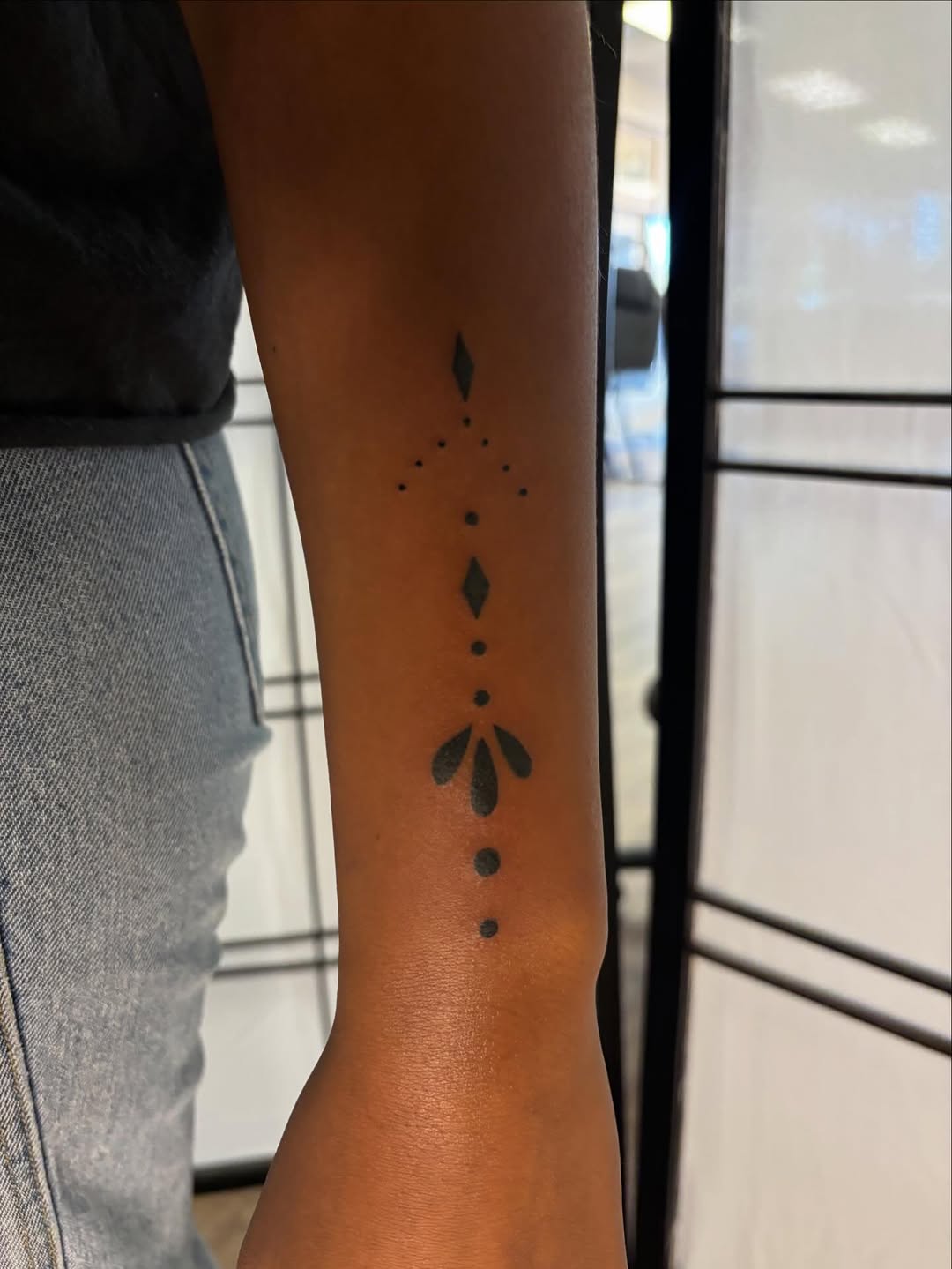 Geometric floral design ornamental tattoo on the forearm by Pres!