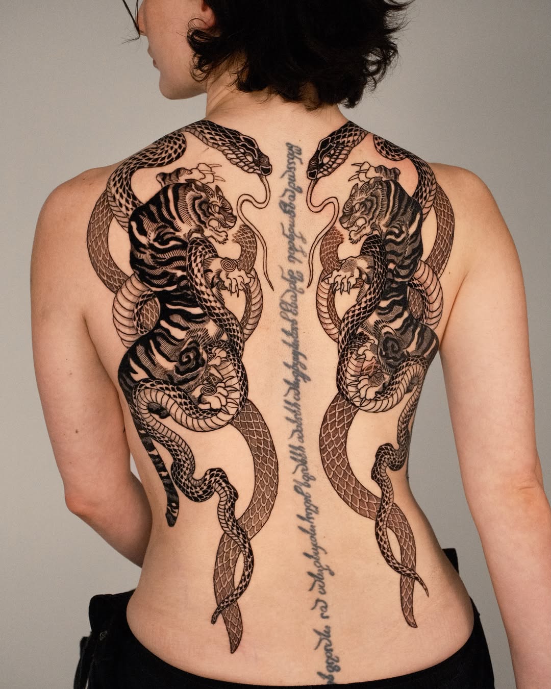 Tigers and snakes with script tribal tattoo on the back by Kubo