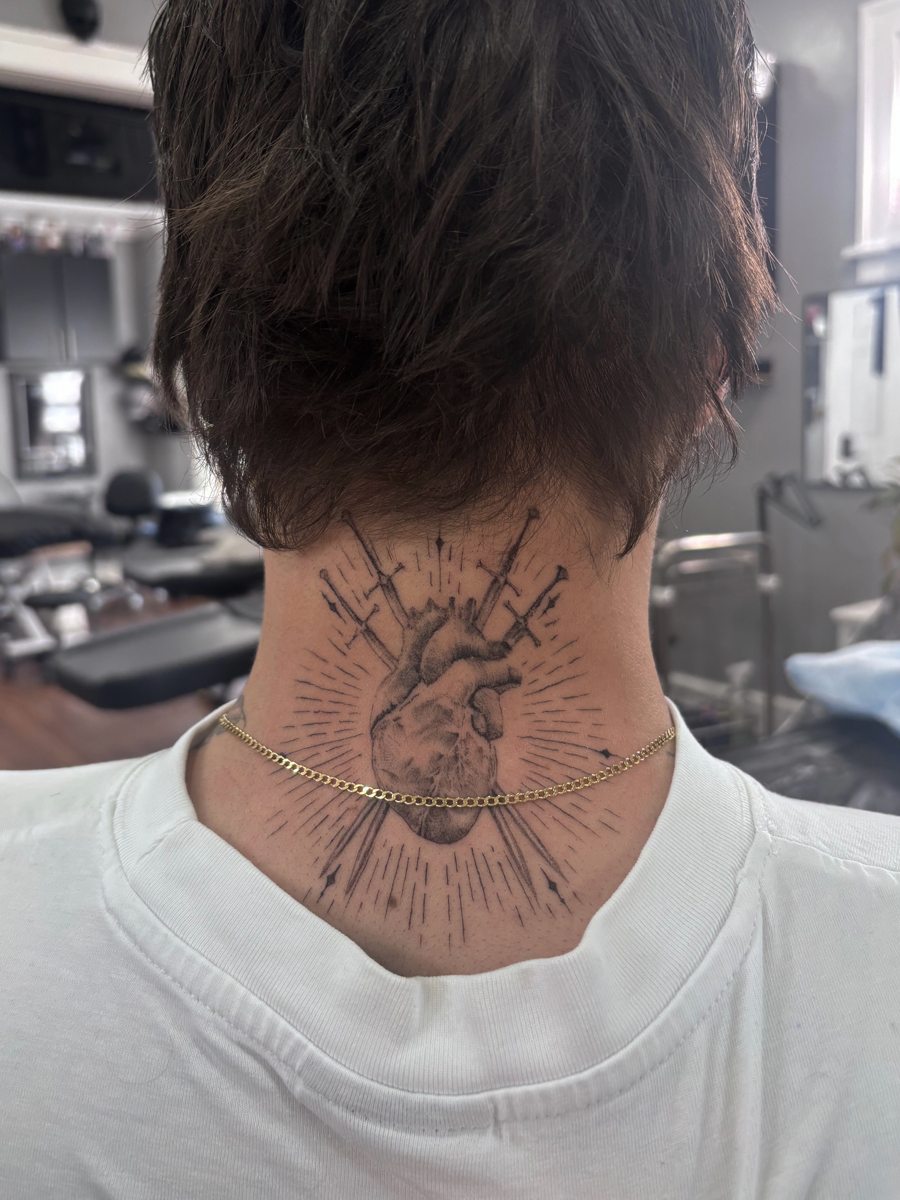 Heart with arrows black and grey tattoo on the neck by Rose