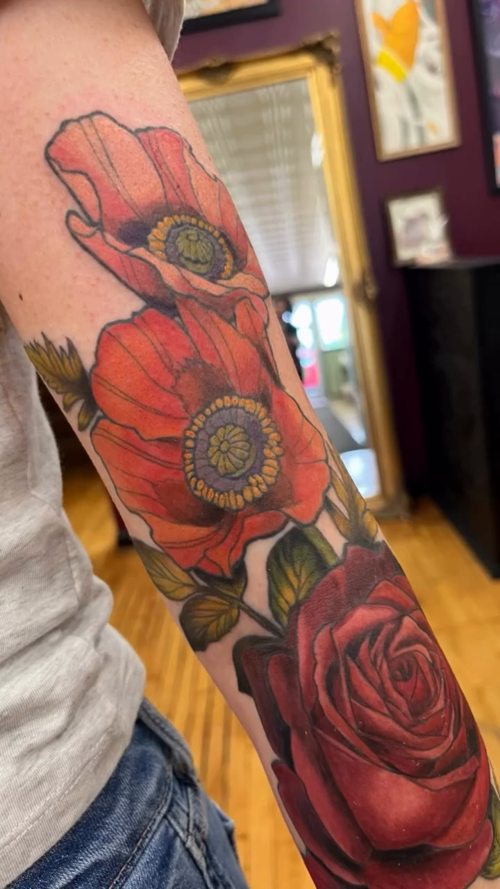Floral sleeve with roses and poppies neo-traditional tattoo on the upper arm by Megan Merrell (Butler)