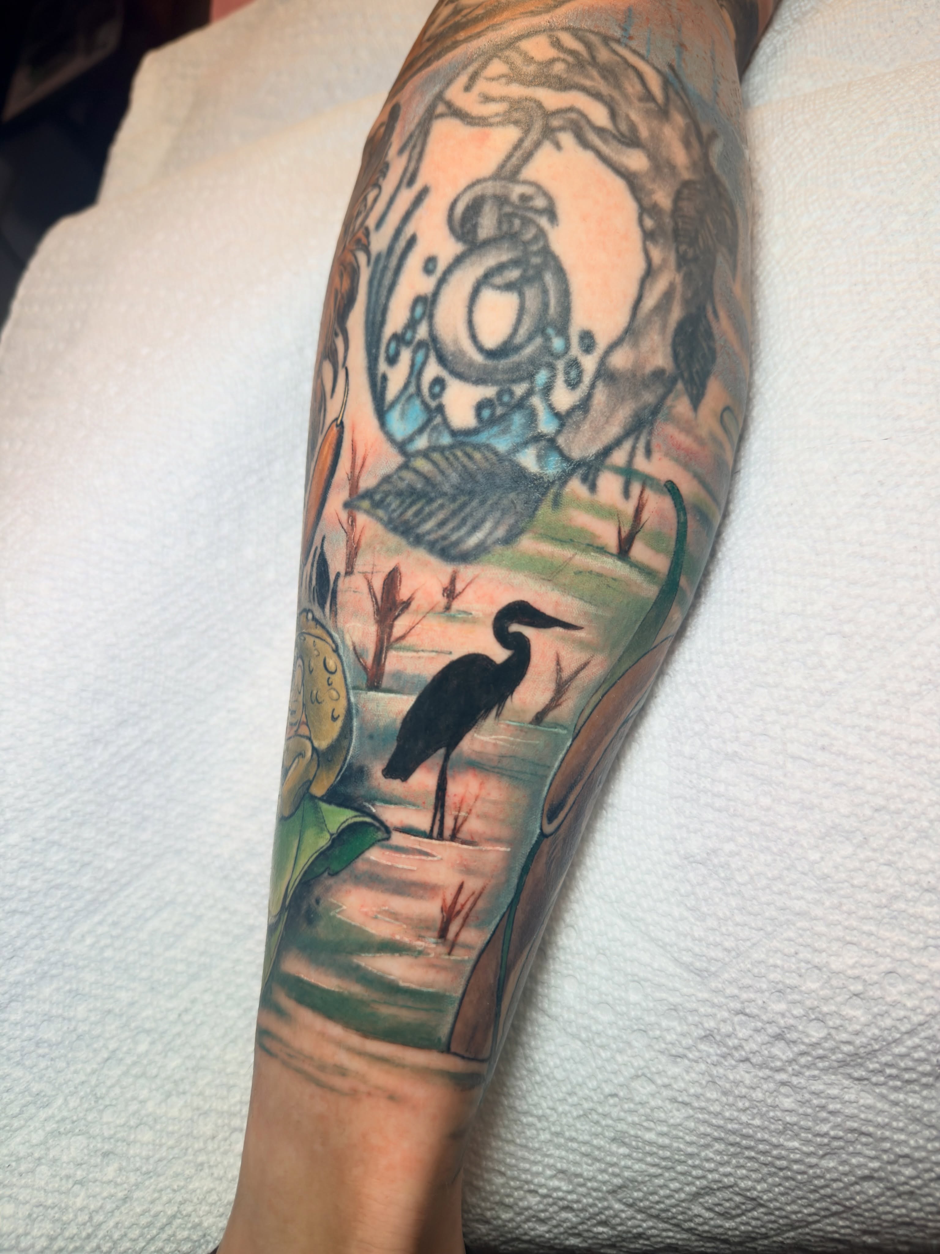Heron and moon American traditional tattoo on the forearm by Jenn Golgan