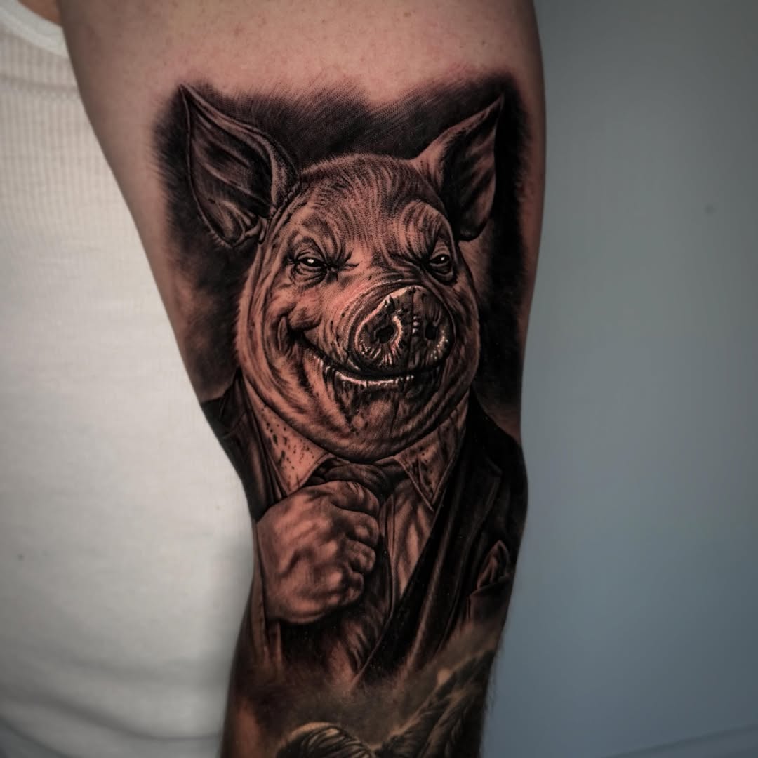 Pig in suit realism tattoo on the forearm by TJ Schunemann