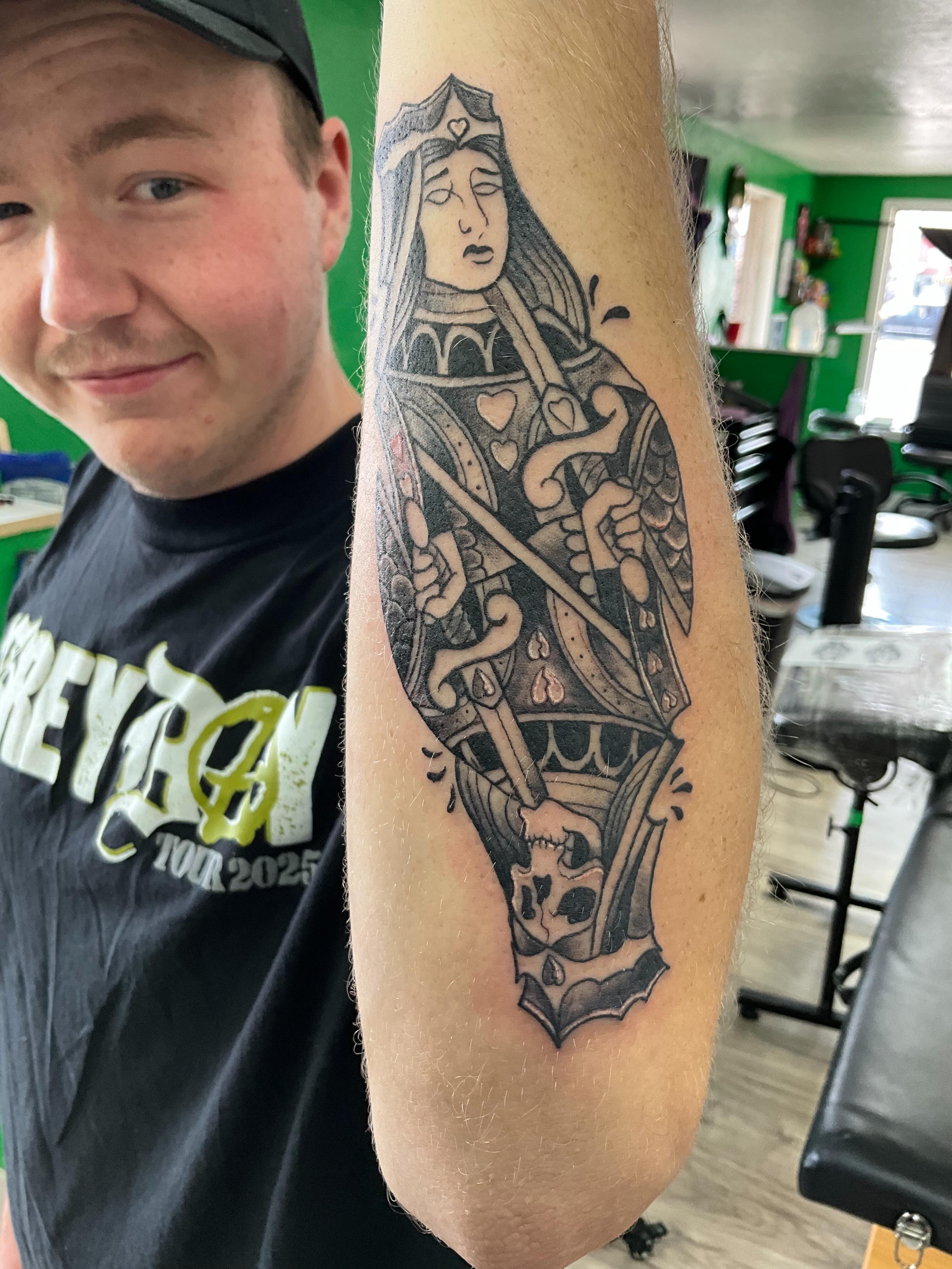 Queen of hearts black and grey tattoo on the forearm by James Ostler