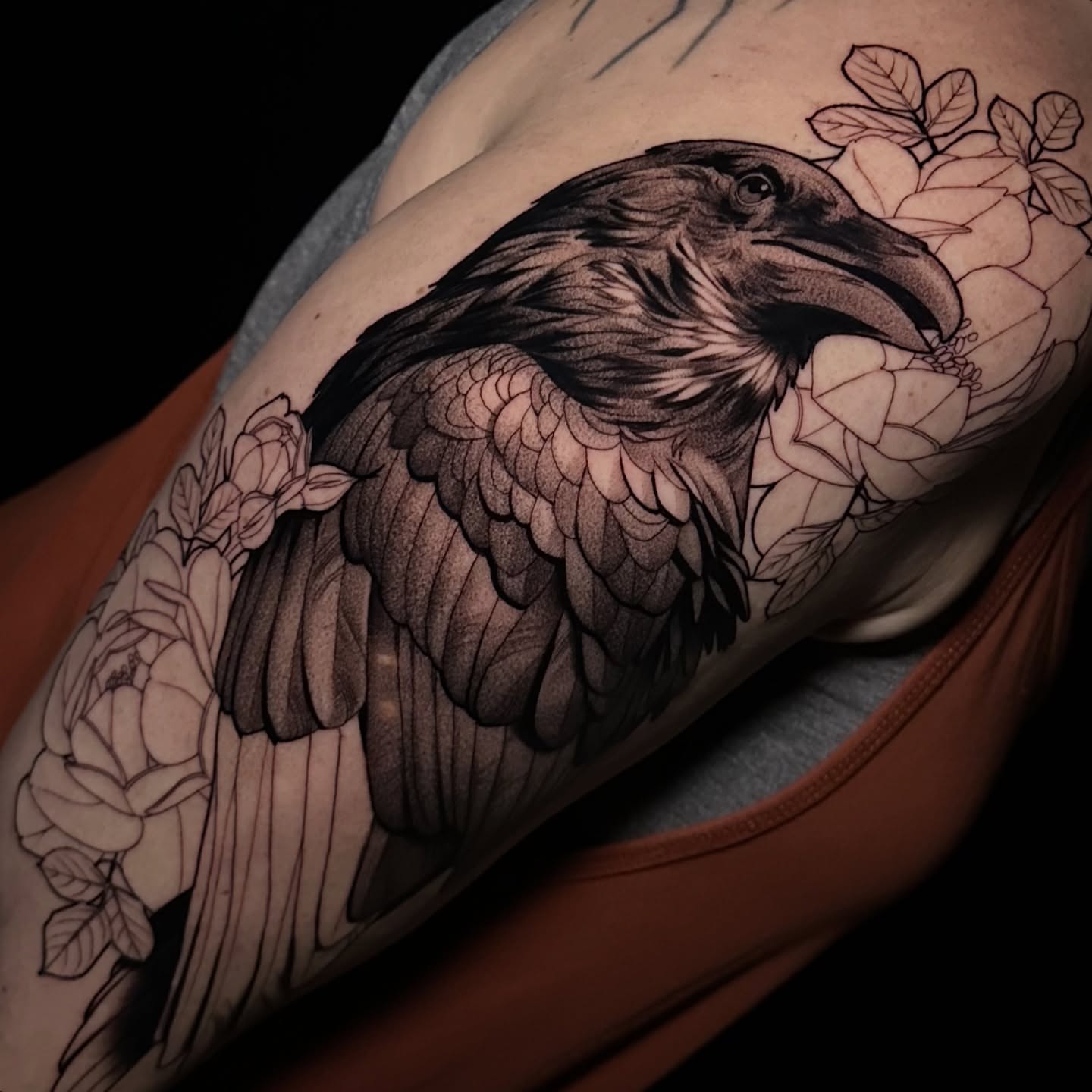 Raven and flowers realism tattoo on the shoulder by Breah Beshore Kirk