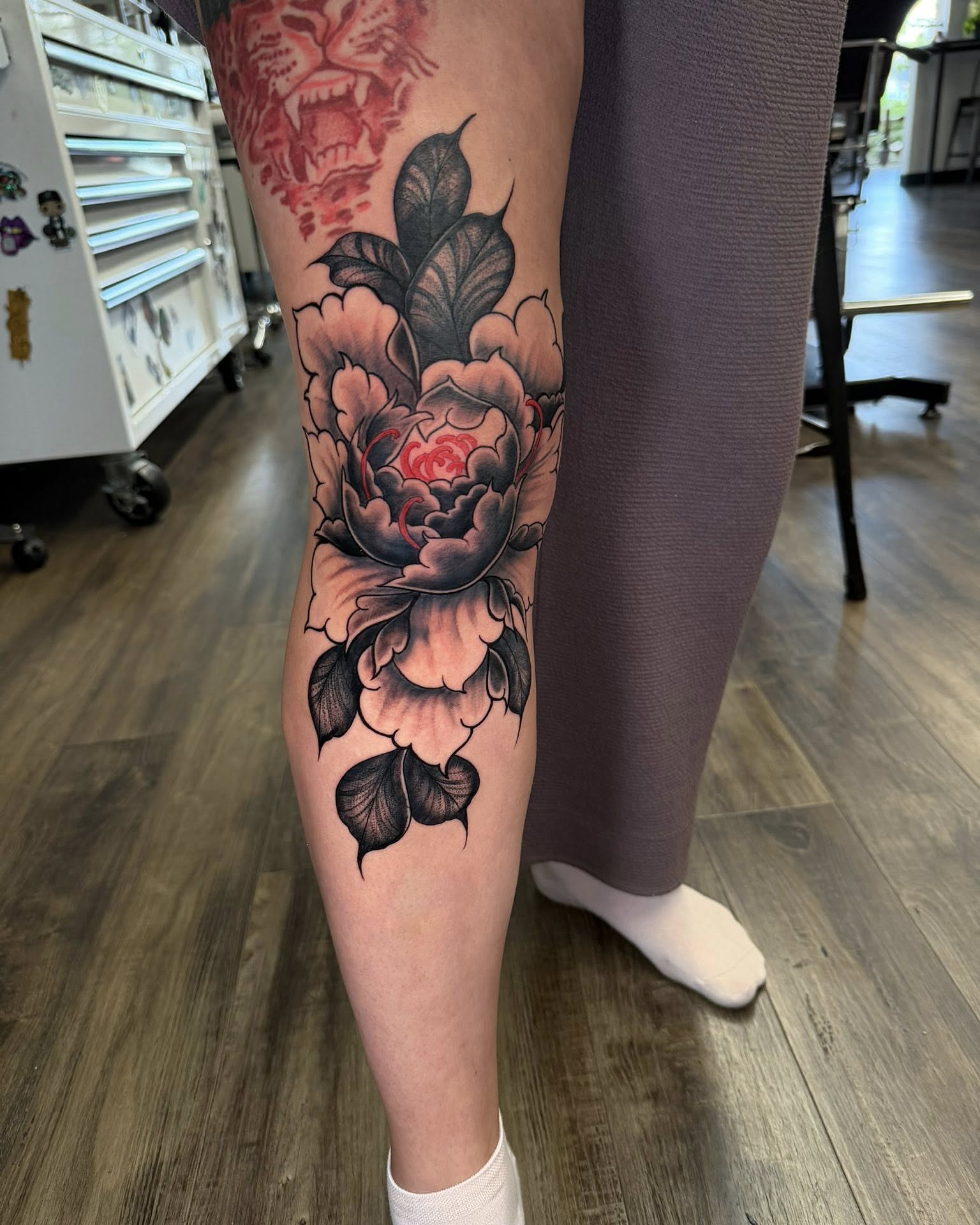 Peony American traditional tattoo on the calf by Chad Meado