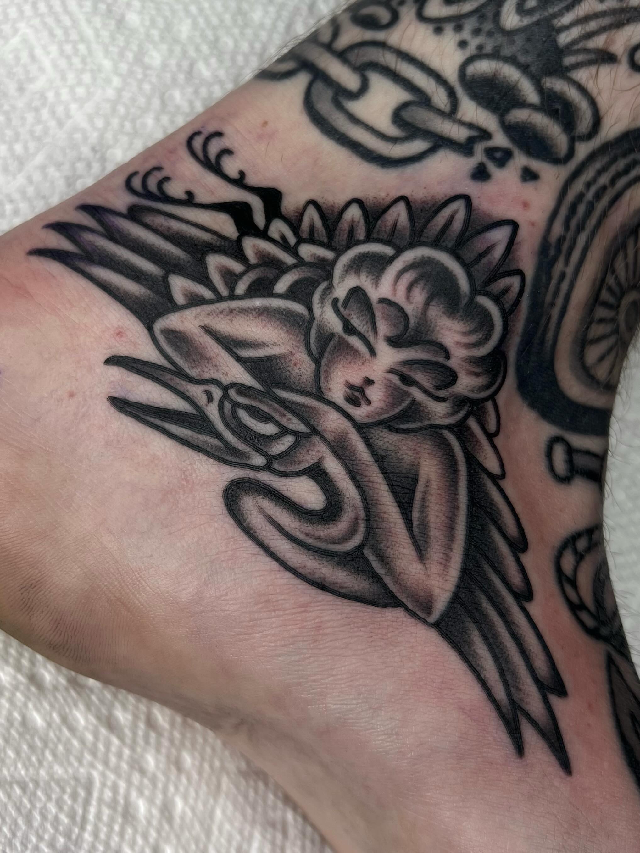 Angel with flower American traditional tattoo on the forearm by ᴍᴀᴛᴛ ᴀʟᴇxᴀɴᴅᴇʀ