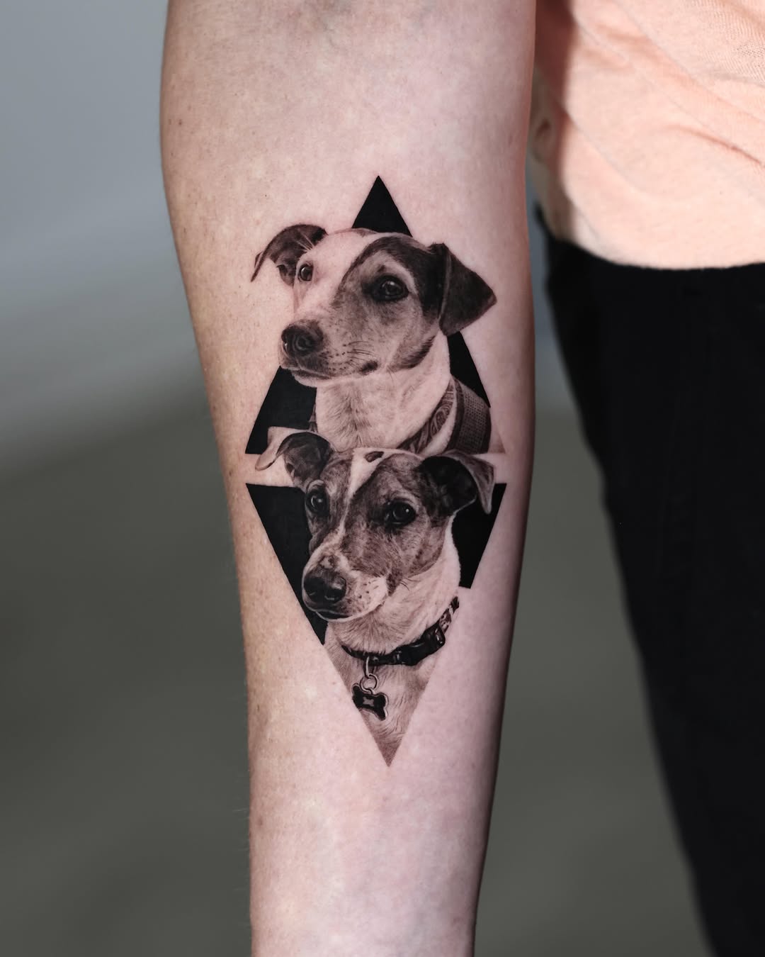 Two dogs in geometric shapes realism tattoo on the forearm by LA Tattoo Yeono
