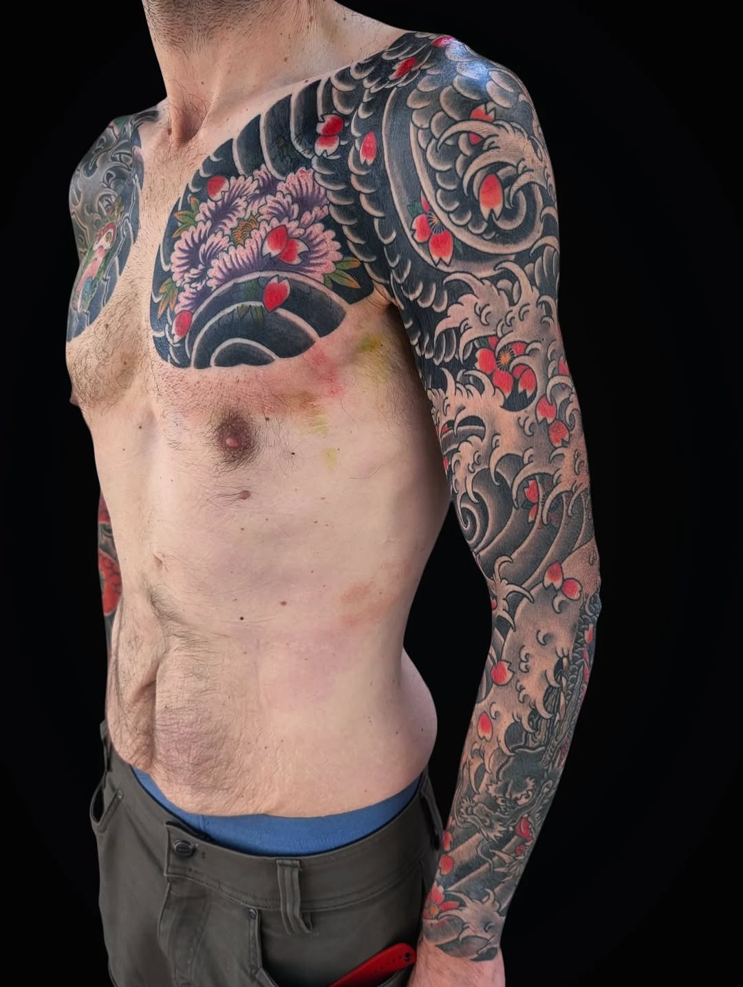 Dragon and peonies with waves Japanese tattoo on the chest by Angela Mukai