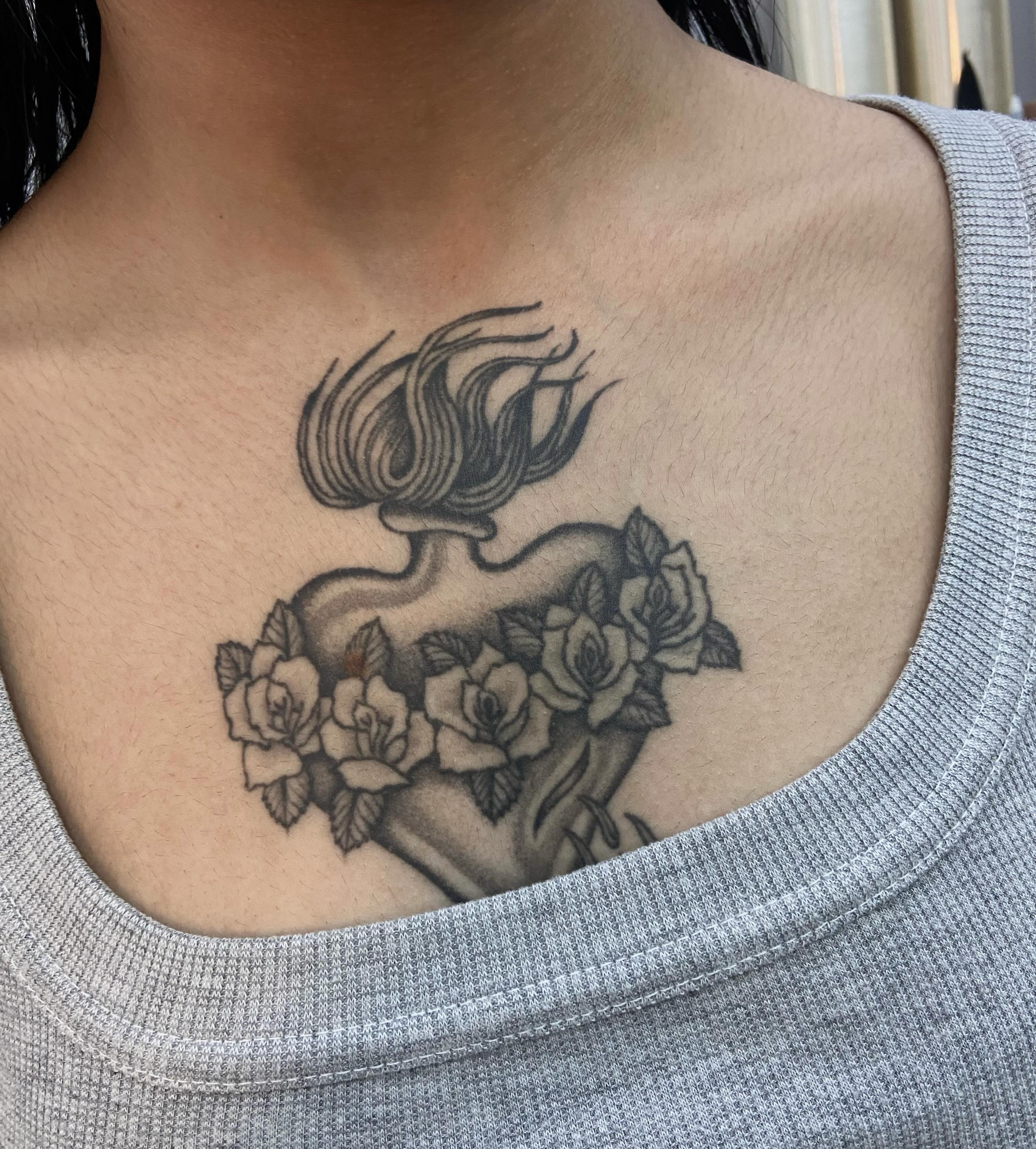 Heart with flowers black and grey tattoo on the chest by Lucas Naganuma