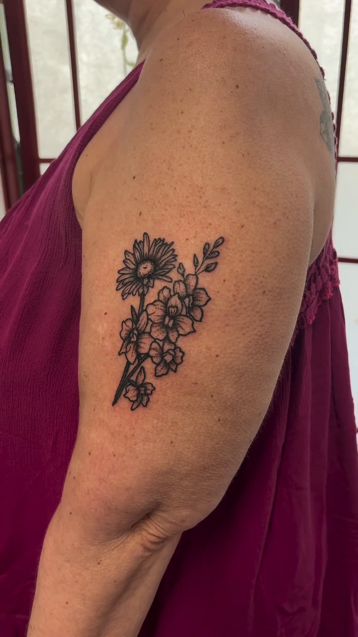 Floral bouquet tattoo watercolor tattoo on the upper arm by CJ