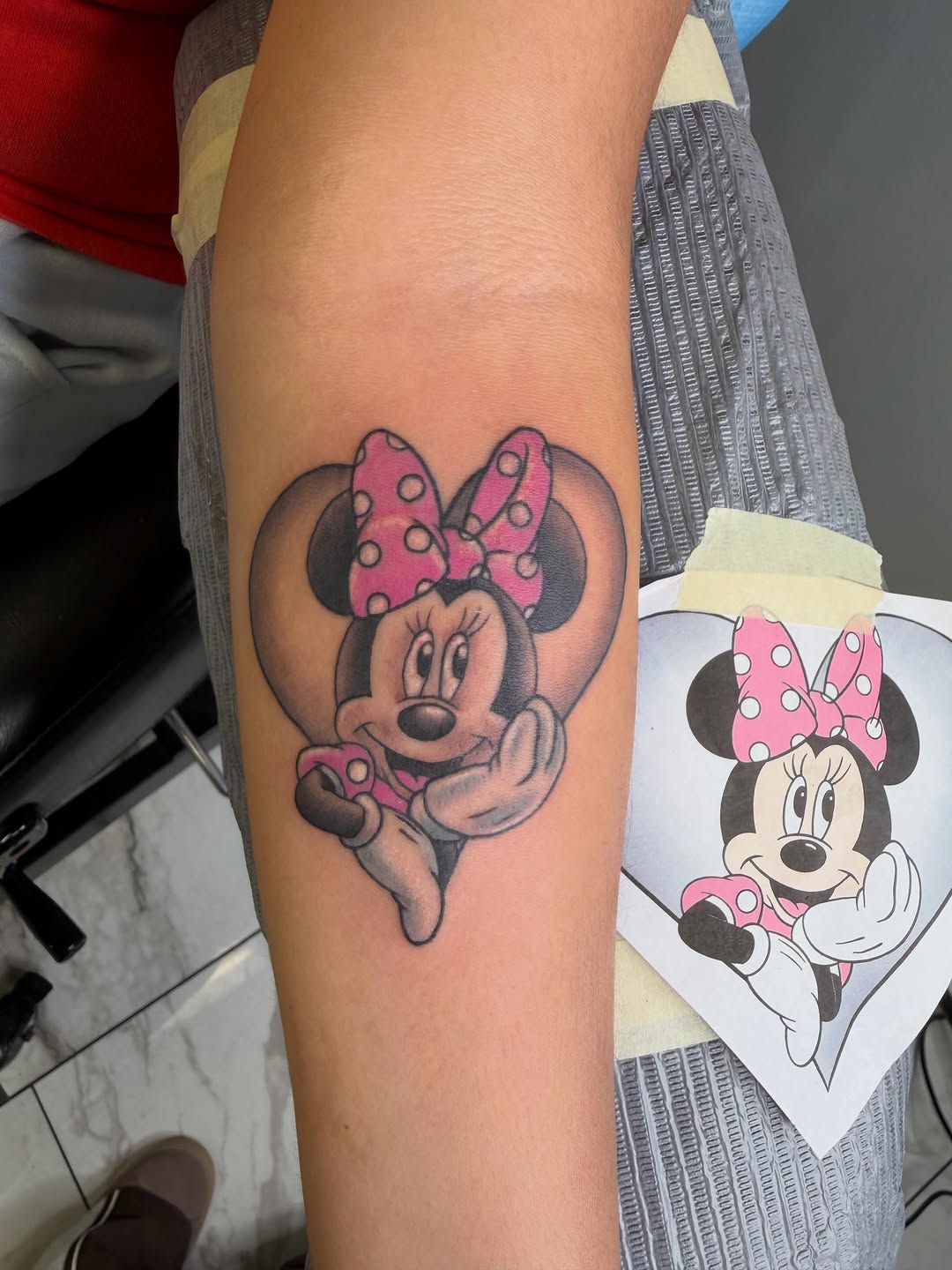 Minnie Mouse in heart new school tattoo on the forearm by linda perez