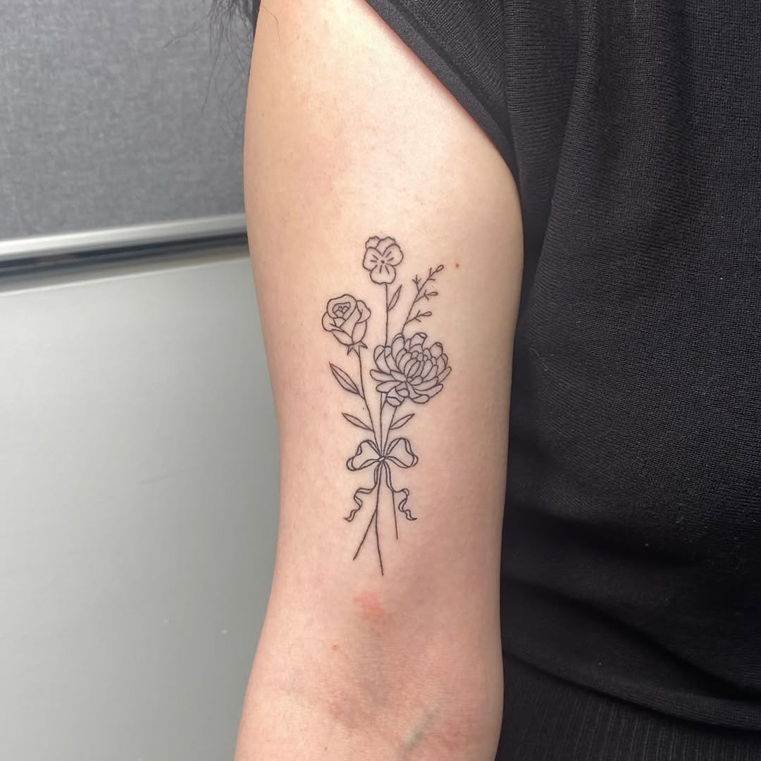 Bouquet of flowers with a bow fine line tattoo on the forearm by 𝓖𝓻𝓪𝓬𝓮 𝓑𝓮𝓵𝓵